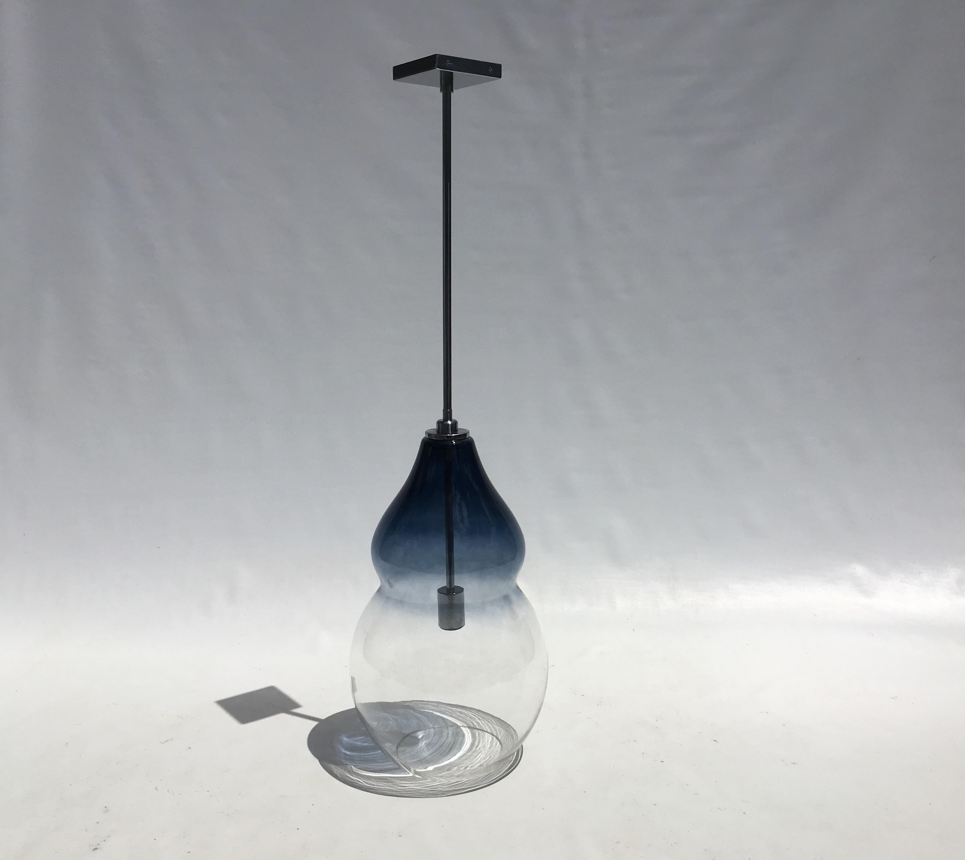 Blue and clear glass pendant with satin chrome stem. Glass body is 20
