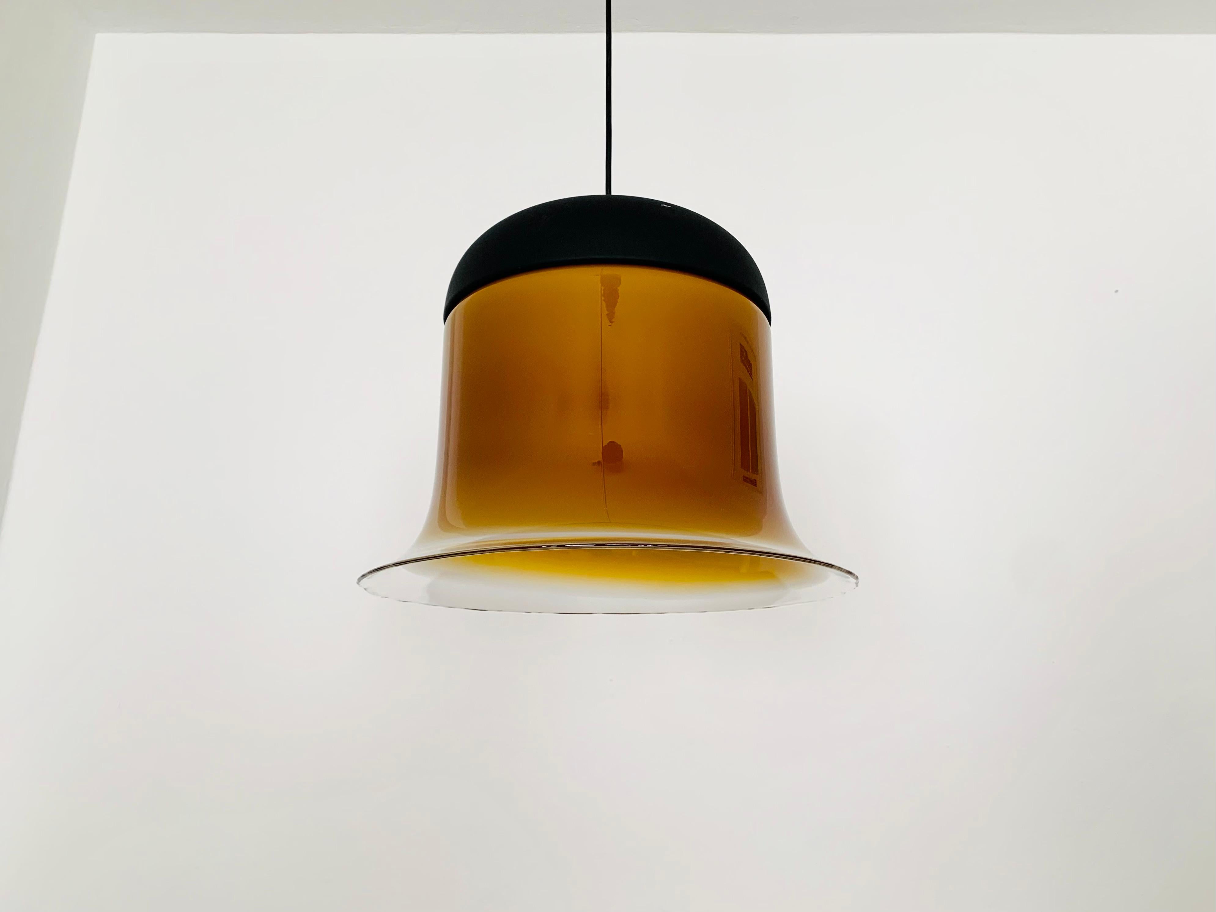 Exceptionally beautiful and large glass pendant lamp from the 1980s.
Very fine and beautiful design which fits wonderfully into any room.
The high-quality glass creates a beautiful and very comfortable light.

Manufacturer: Peill and