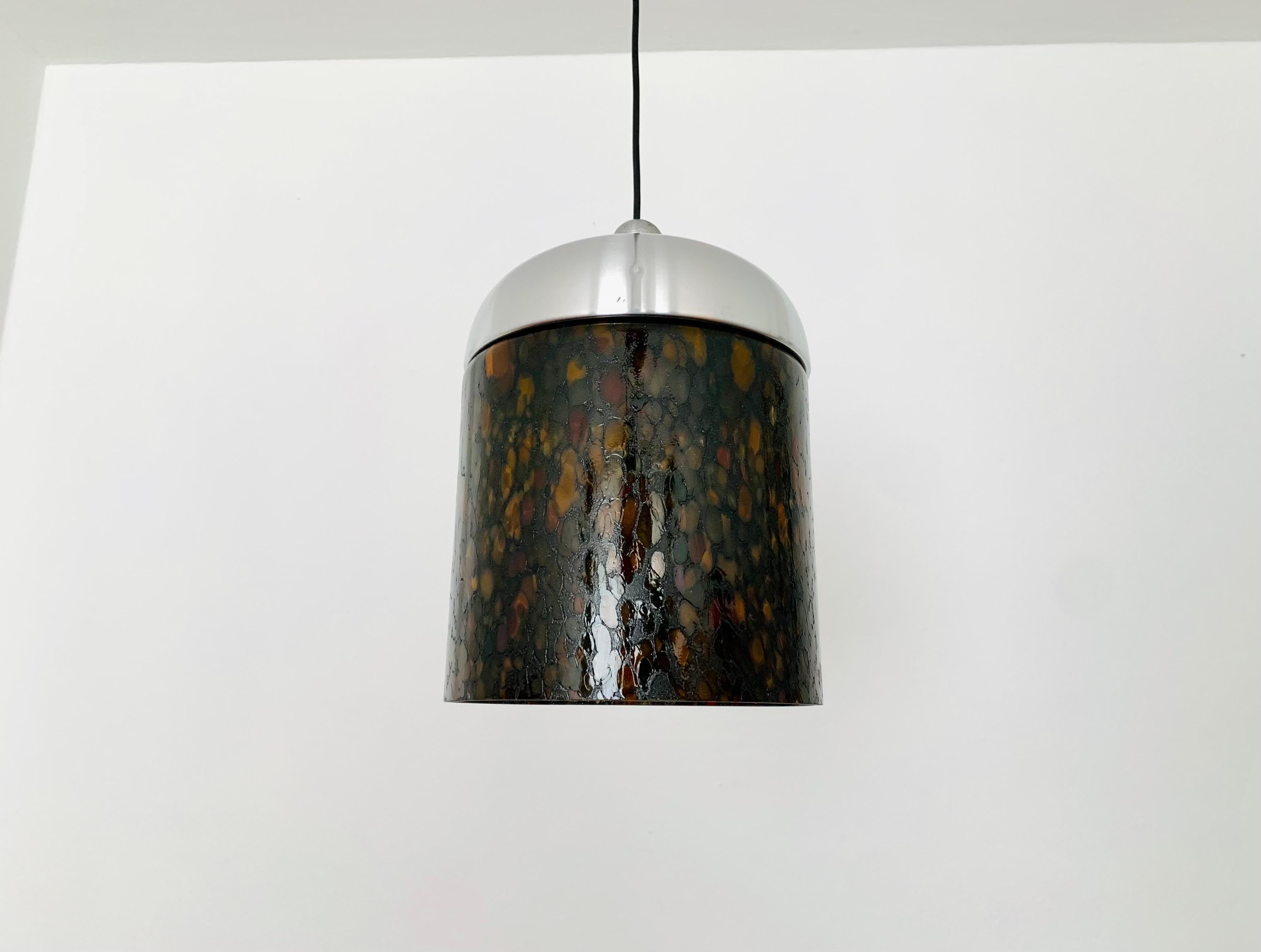 Exceptionally beautiful glass pendant lamp from the 1980s.
Very fine and beautiful design which fits wonderfully into any room.
The high-quality glass creates a beautiful and very comfortable light and a spectacular play of colors on the