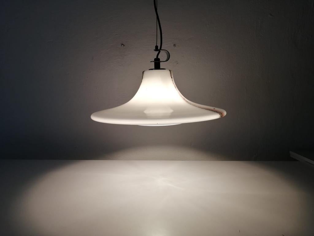 Large opaline glass pendant lamp by Peill & Putzler, 1970s, Germany

Peill & Putzler 
Ufo design glass pendant lamp
1970s, Germany
Adjustable height available
The lampshade is attached to the canopy by a metal cord
Lampshade is in good