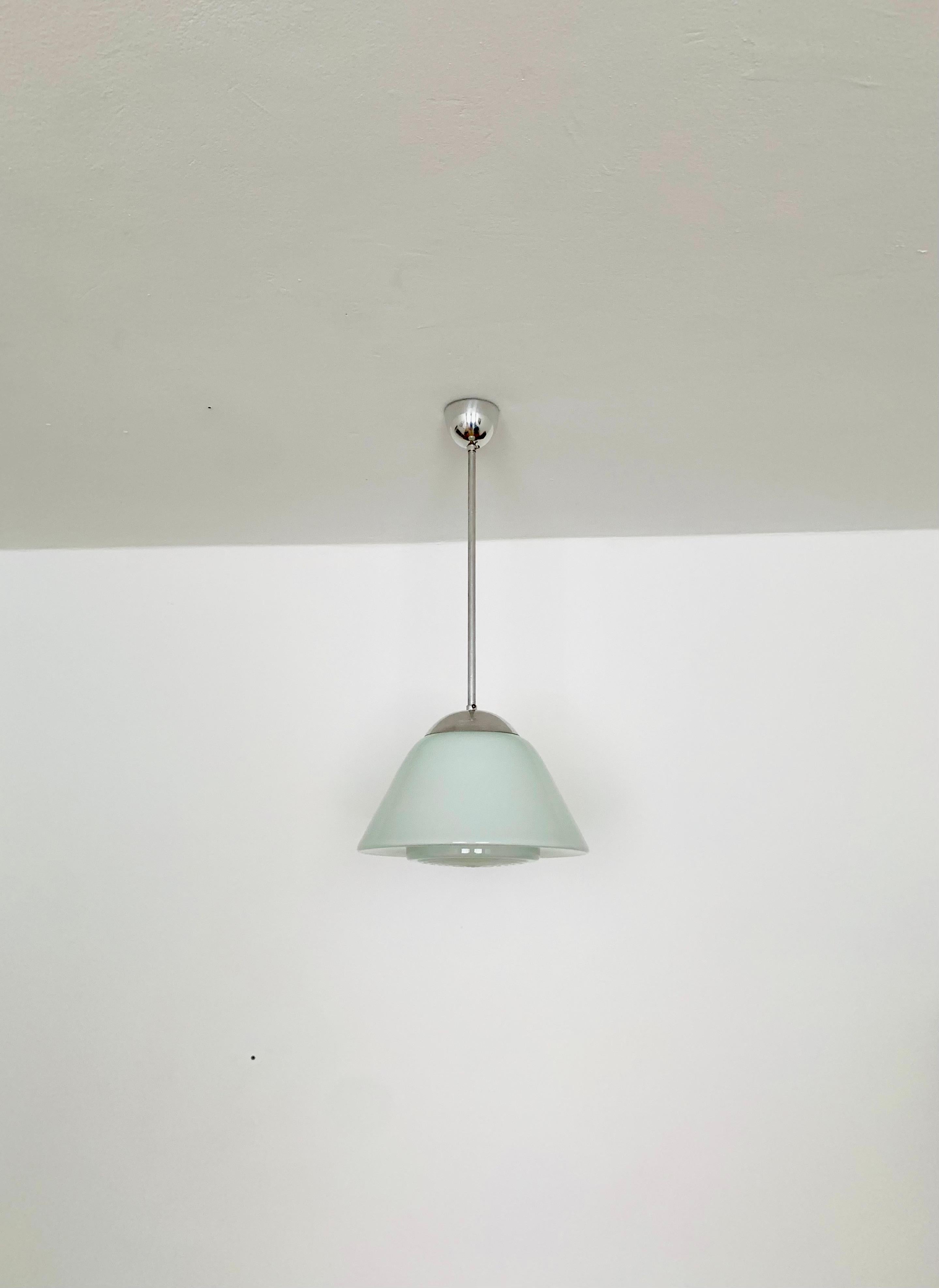 Exceptionally beautiful ceiling lamp from the 1950s.
The lamp emits a very pleasant, warm light.
Wonderful shape and a timeless classic.

Manufacturer: Peill and Putzler
Design: Prof. Wilhelm Wagenfeld

Condition:

Very good vintage condition with