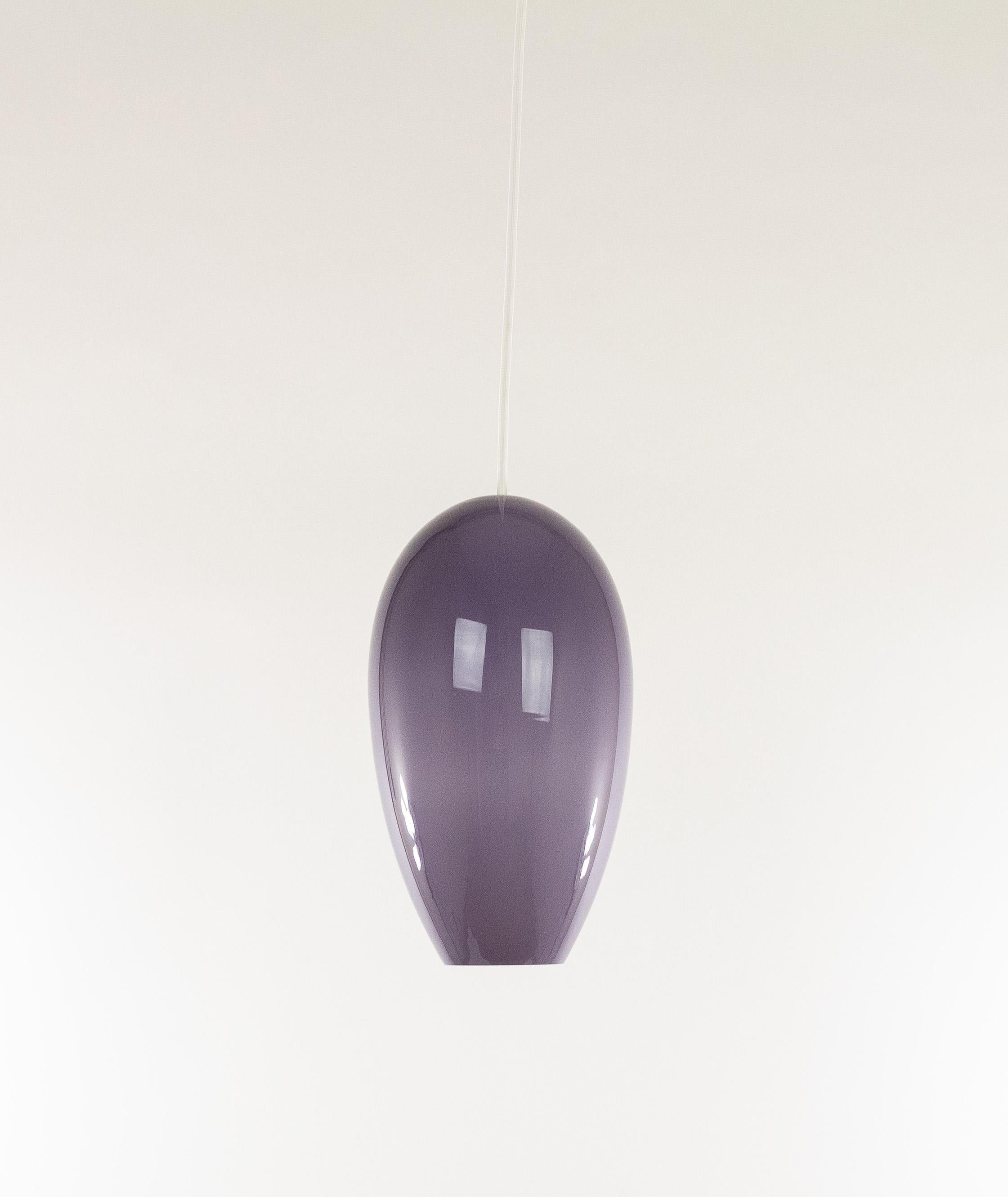 Lilac blown glass pendant 'Life' by Jo Hammerborg for Fog & Mørup in collaboration with Danish glass producer Holmegaard Glassworks.

Life is a medium sized hand-blown glass pendant, emitting correct direct luminance and a soft and pleasant