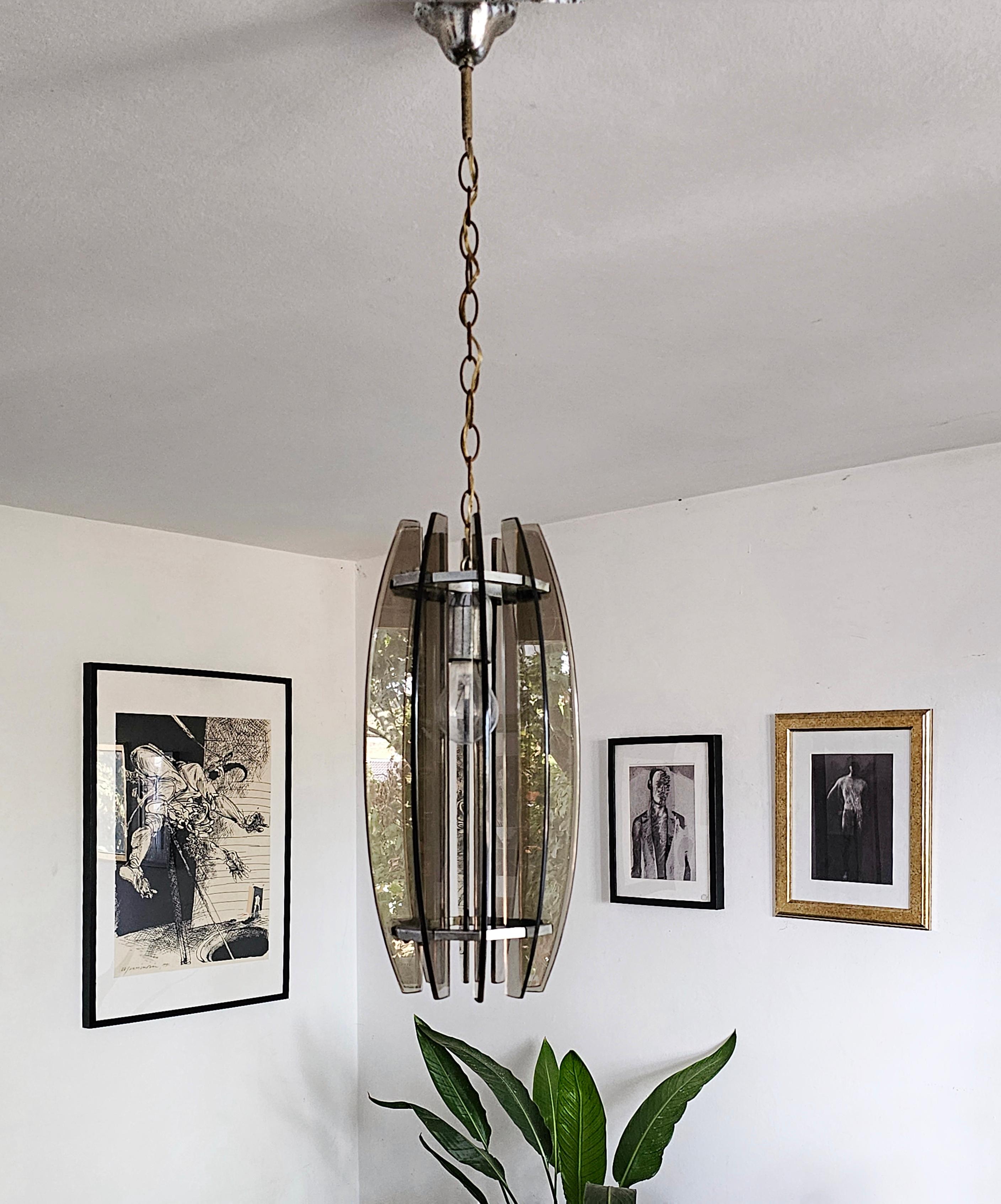 In this listing you will find a beautiful, small chandelier manufactured in style of Fontana Arte. It features chrome fixture with smoked Murano glass. Due to its size this piece of lighting is perfect for smaller spaces - hallways, kitchen,