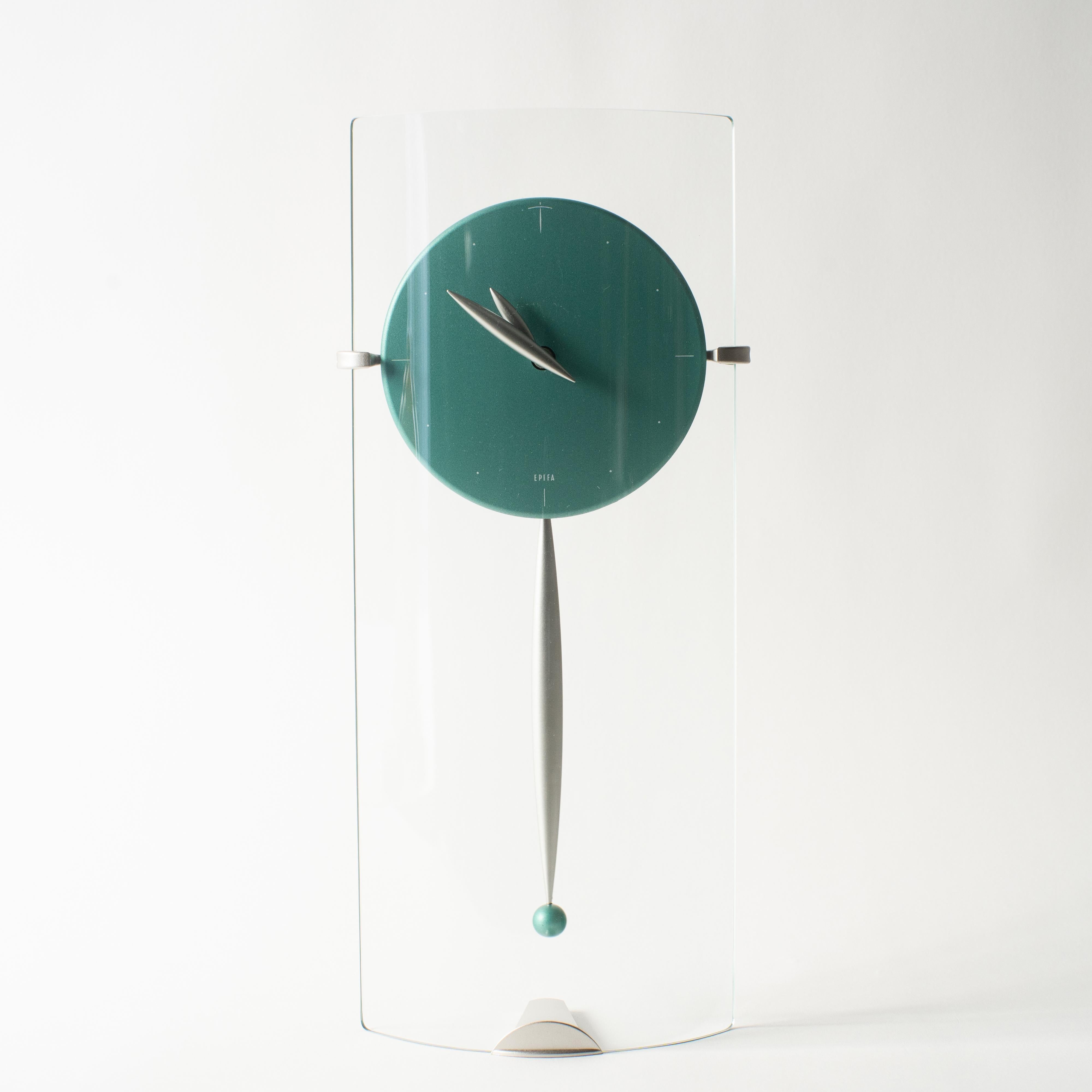Glass pendulum clock by Sessa. It can be used as both standing on the table and hanging on the wall. Takashi Kato designed a lot of clocks in the 1980s-1990s. Some of clock collections were released from Neos Lorenz in European Market. Which sold