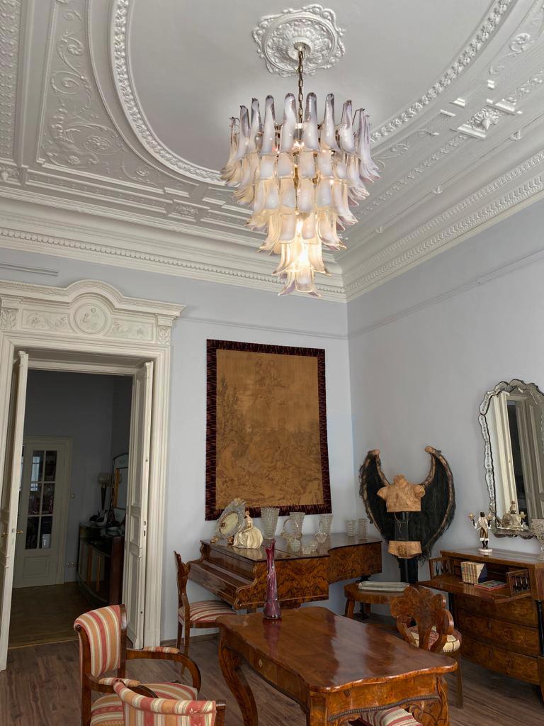 Hand blown glass chandelier composed by 75 glass petals (transparent and white “lattimo”) in a chrome frame.
Dimensions: 65 inches (165 cm) height with chain, 37.40 inches (95 cm) height without chain, 31.50 inches (80 cm) diameter
Dimension