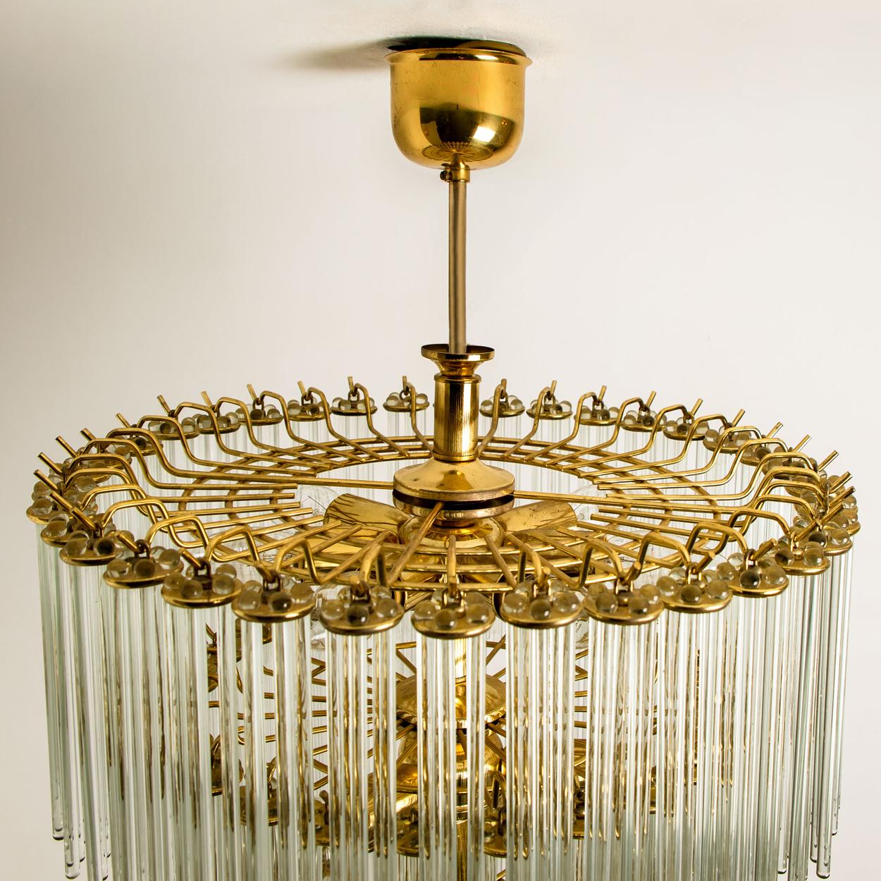A Italian Mid-Century Modern glass rod and brass Gaetano Sciolari flush mount for Lightolier, circa 1960s-1970s. Illuminates beautifully.
With round form clusters of light catching optical quality glass rods) sitting on a brass plated steel back