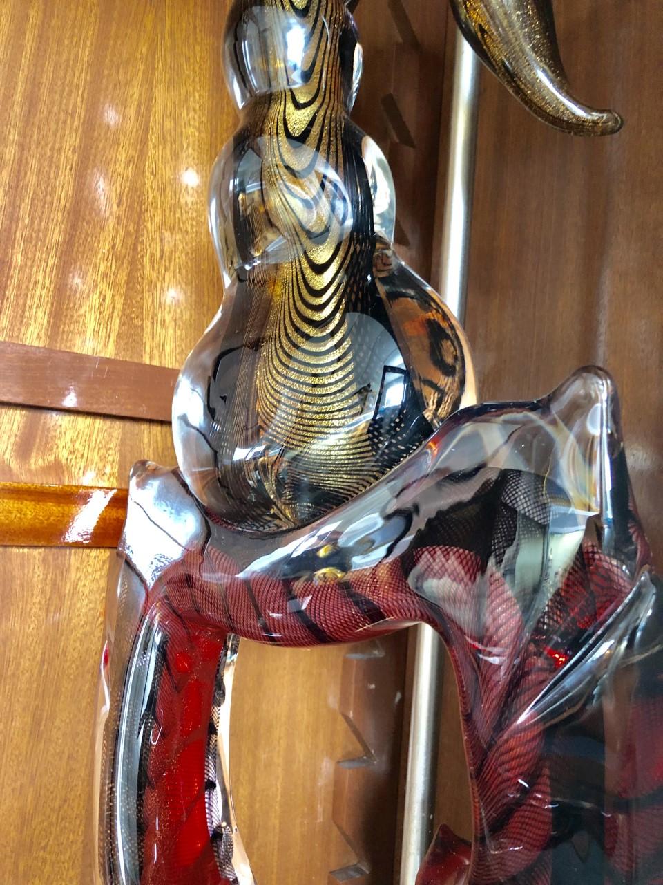 A fascinating glass figure of a scorpion
Signed.
Designed as a scorpion with a metal and marble stand
Measures: Height 26 in., (66.04 cm.), width 10 1/2 in., (26.67 cm.), depth 6 3/4 in. (17.14 cm.).
 
 
