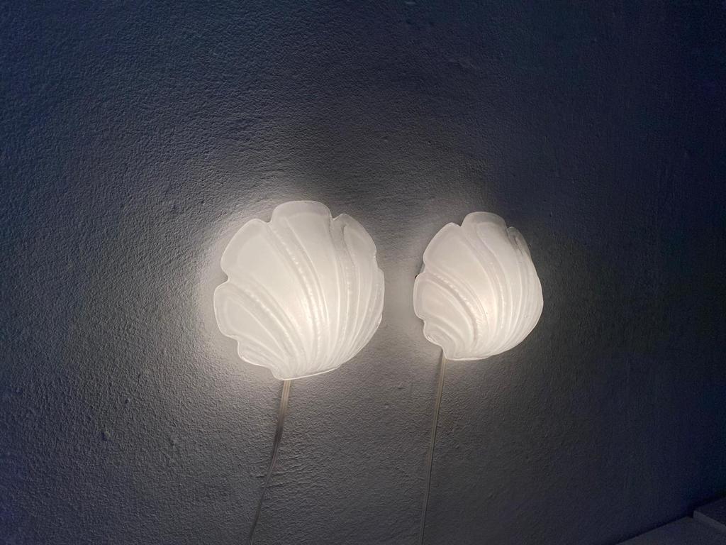 Glass shell shaped rare pair of sconces by Limburg, 1970s Germany

Very nice high quality wall lamps.

Lamps are in very good vintage condition.

These lamps works with E27 standard light bulbs. 
Wired and suitable to use in all countries.