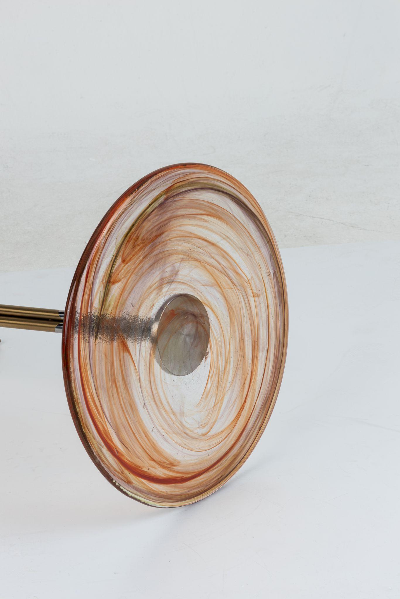 Flat Glass is the prefect unity of artisanal hand work and machine work. Glass part is produced by sculptor Tina Varon. Due to artisanal hand work of glass, each flat side table is one-of-a-kind. There may be slight differences in the dimensions due