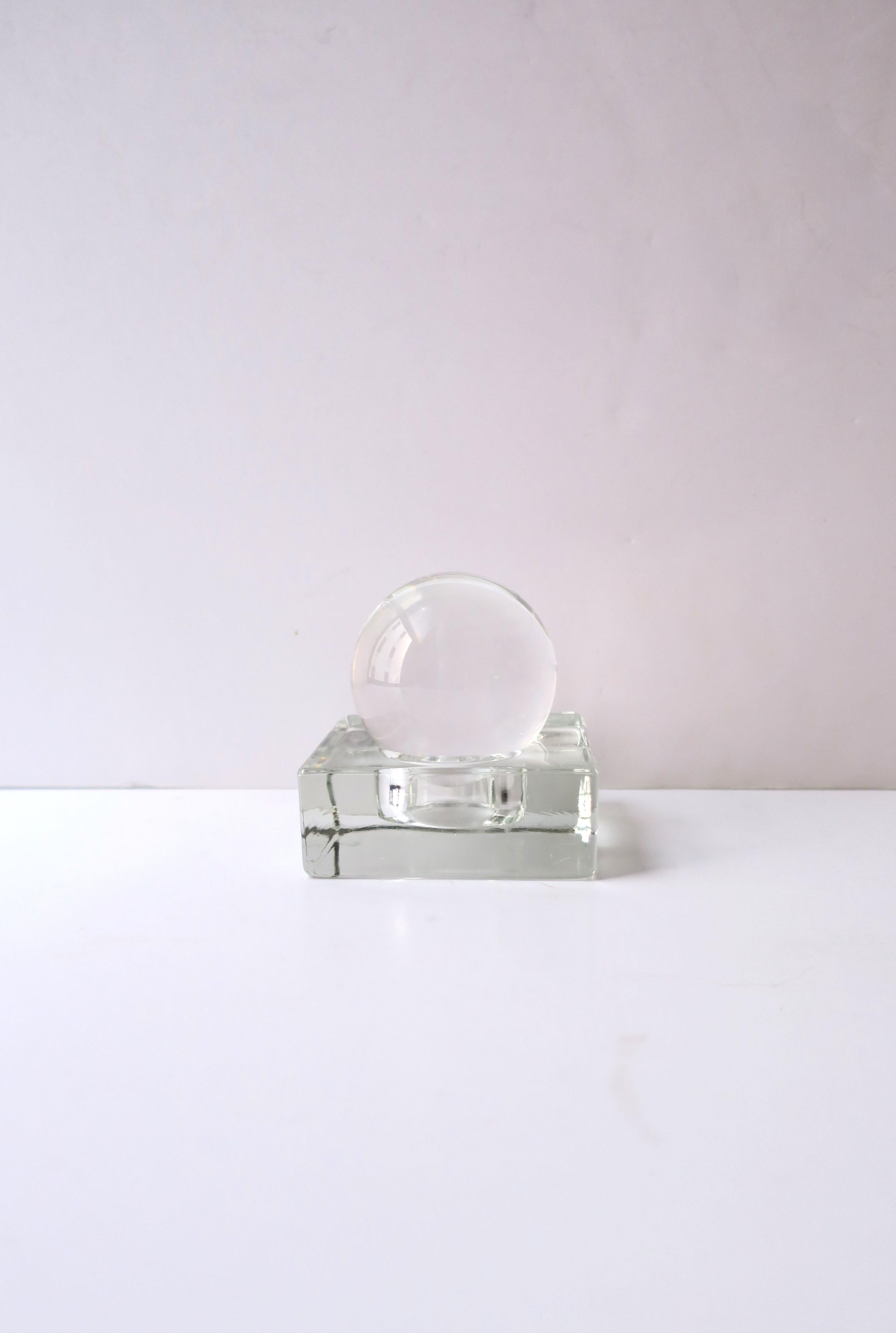 A transparent glass sphere on a square glass base decorative object or paperweight, in the Modern style, circa late-20th century. A great decorative object for a desk, library, shelf, etc. Very good condition as shown in images. 

Letter holder