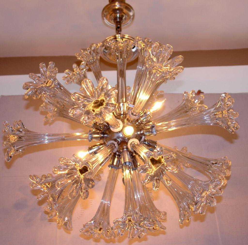 A circa 1960's Italian Sputnik chandelier with extending hand blown glass flowers, a chrome-plated body and eight lights. 

Measurements:
Height: 35