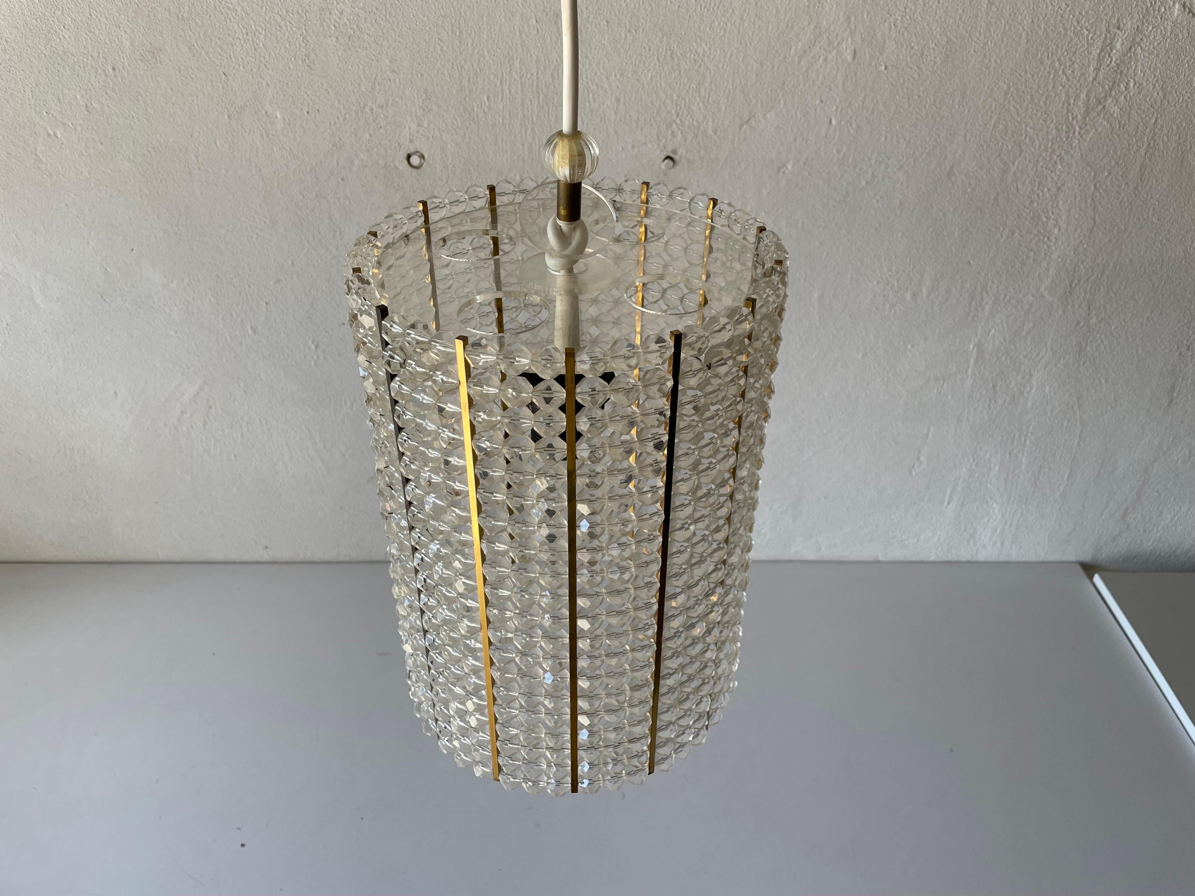 Cylinder design Lux pendant lamp with glass stones by Palwa, 1960s, Germany. 

It is very ideal and suitable for all living areas.


Lamp is in good condition. No damage, no crack.
Wear consistent with age and use.

This lamp works with E27