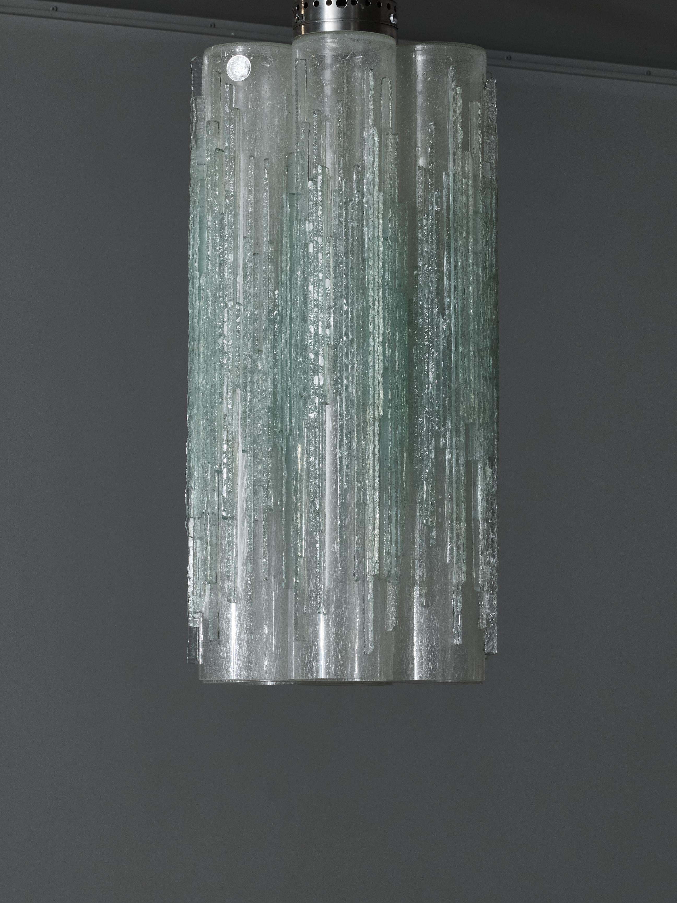 Suspension made of seven tubes of glass attached in circle, covered with signature Poliarte live edge glass decors.

Original Poliarte Label.

Poliarte is an Italian lighting company that was founded by Albano Poli in 1968 in Verona. The company