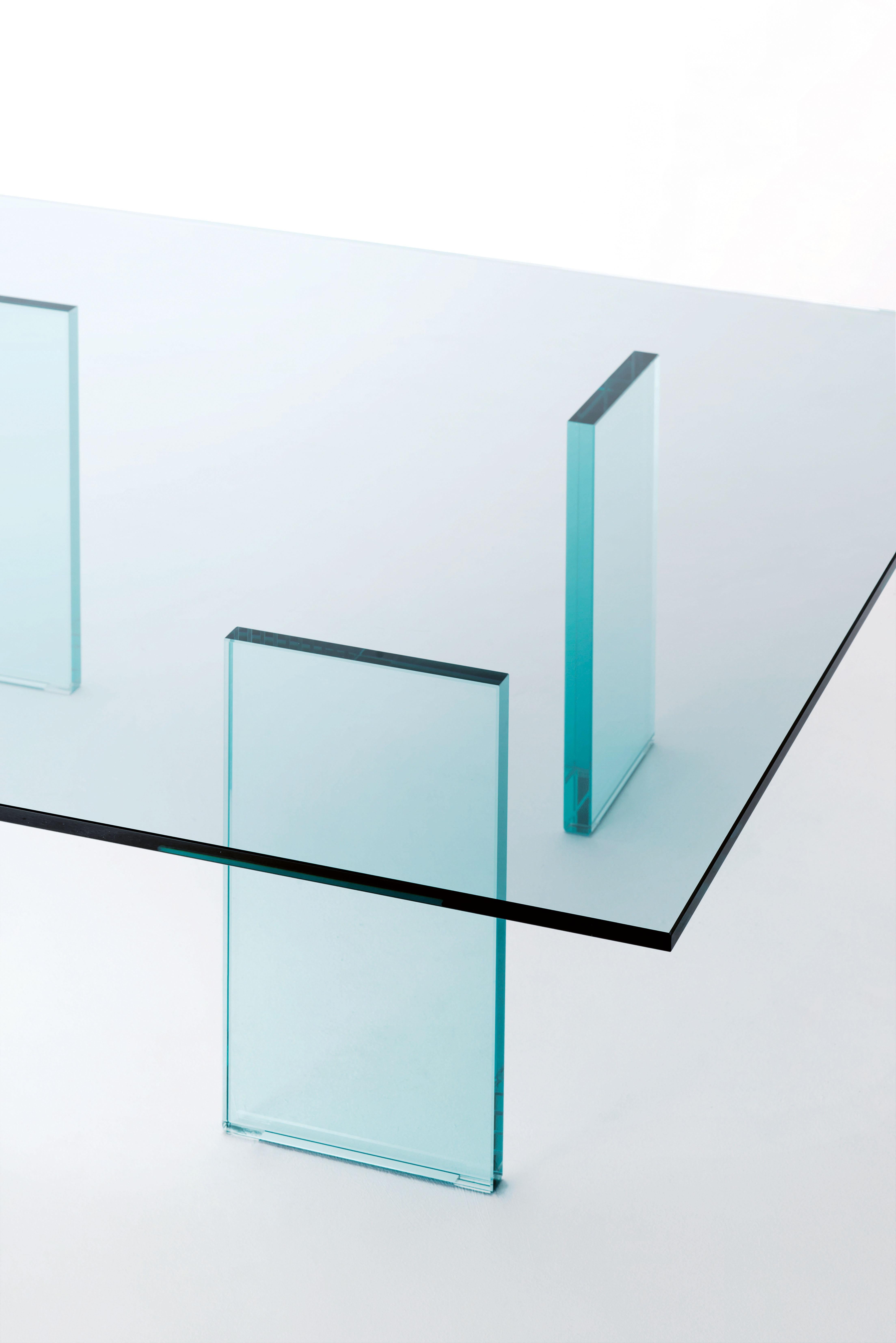 Shown here is the glass table 1976. The low table characterised by the very refined minimal aspect with feet in mm. 24 thick transparent glass, thermo-welded to the top in mm. 12 thick transparent tempered glass. Historical and iconic product of the