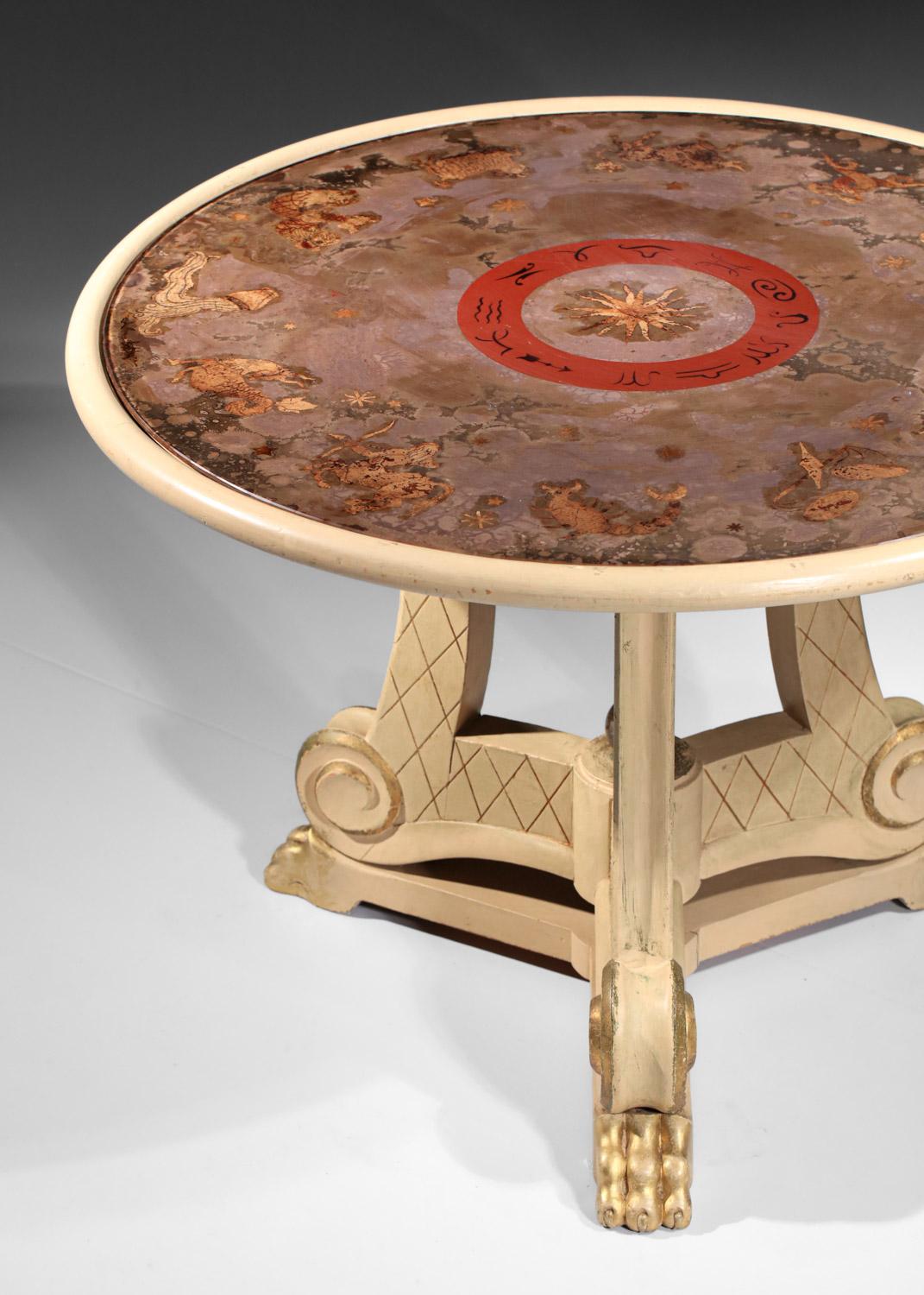 Pedestal table from the 40's, attributed to Maison Jansen, work in the taste of Robert Pansard. Painted and carved solid wood table top, superb eglomized glass top representing the sign of the zodiac. High-quality craftsmanship. Beautiful vintage