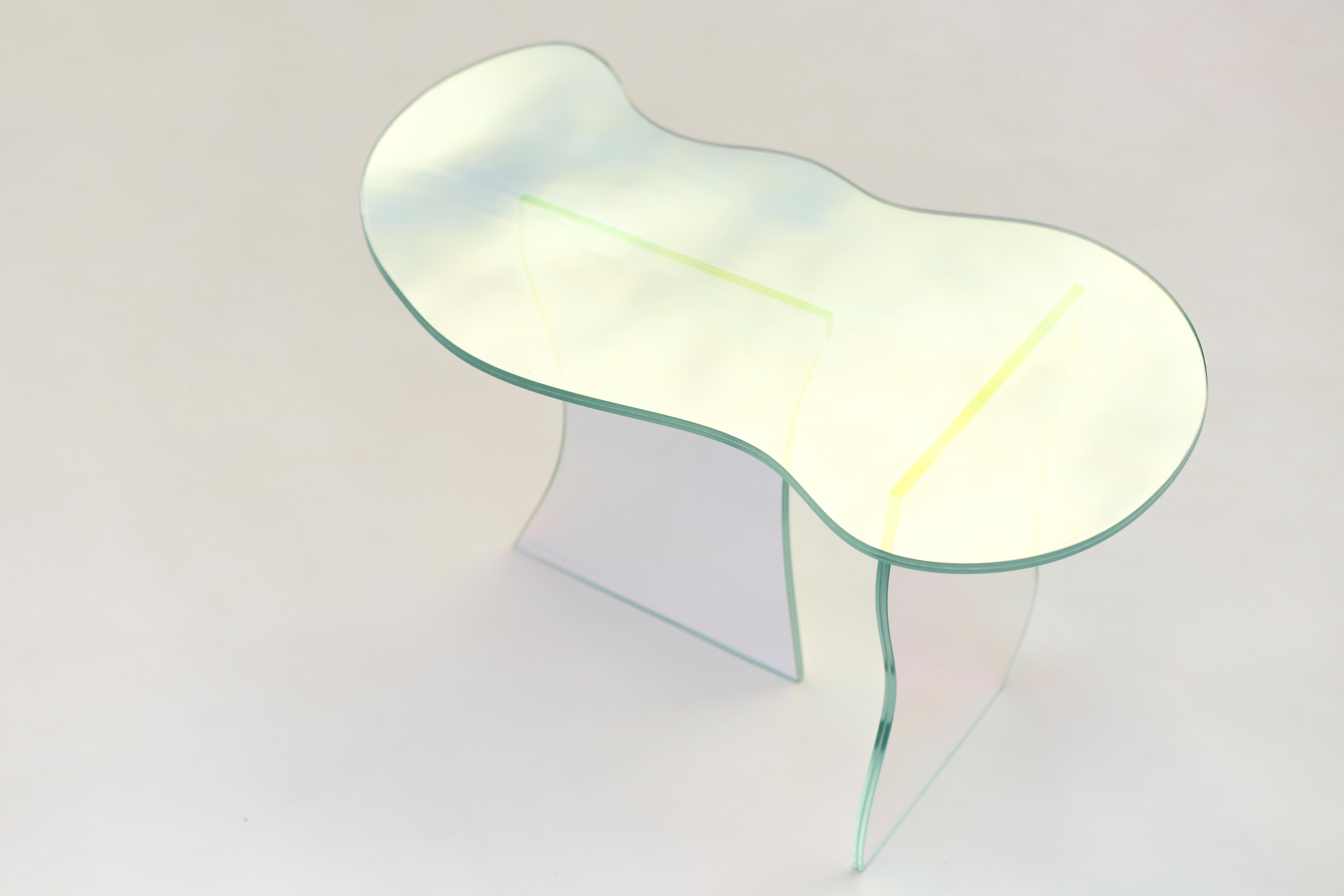 Glass table by Brajak Vitberg
Materials: Glass, Dichroic film
Dimensions: 77 x 43 x 40 cm

Bijelic and Brajak are two architects from Ljubljana, Slovenia.
They are striving to design craft elements and make them timeless through experimental