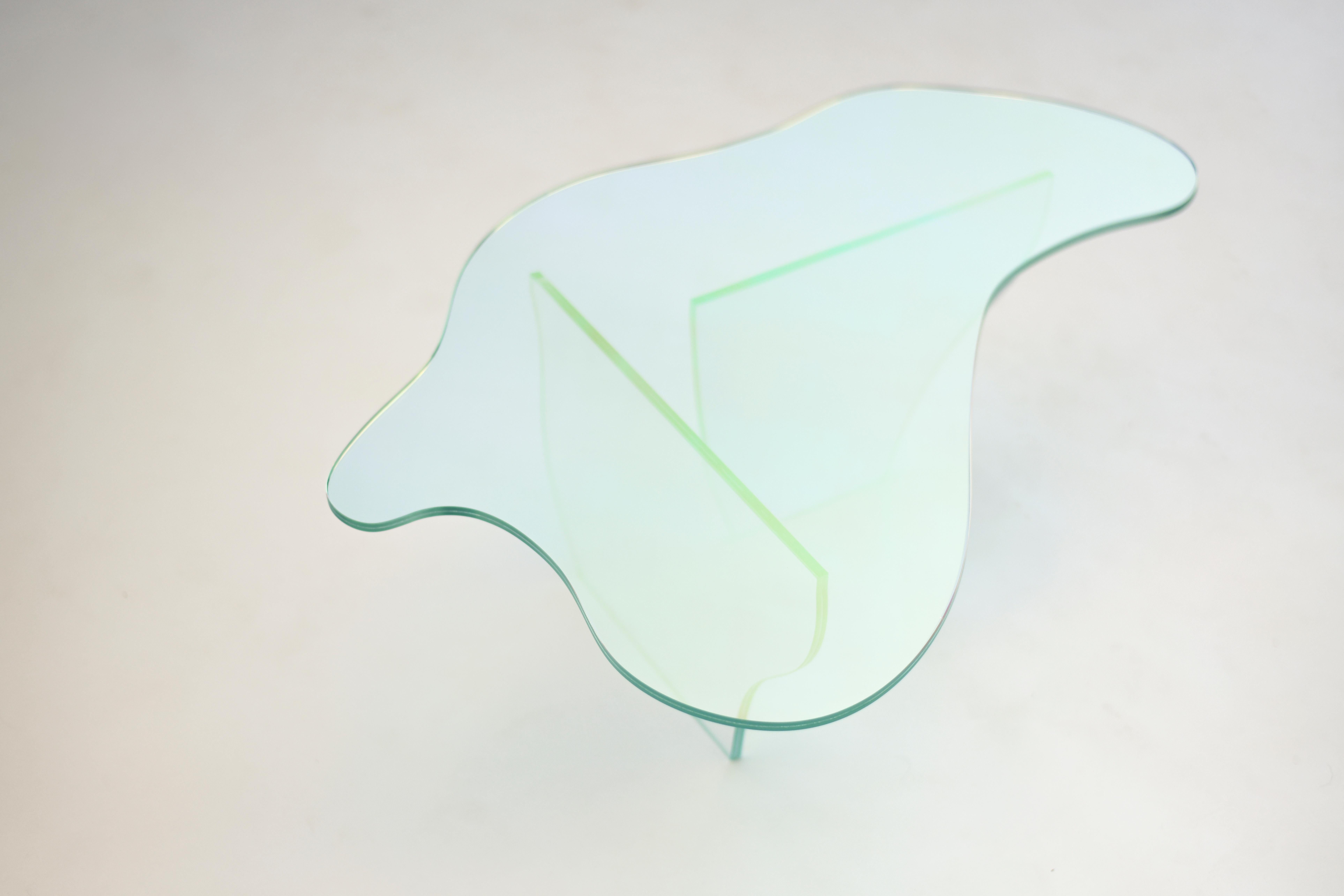 Glass table by Brajak Vitberg
Materials: Glass, Dichroic film
Dimensions: 87 x 57 x 30 cm

Bijelic and Brajak are two architects from Ljubljana, Slovenia.
They are striving to design craft elements and make them timeless through experimental