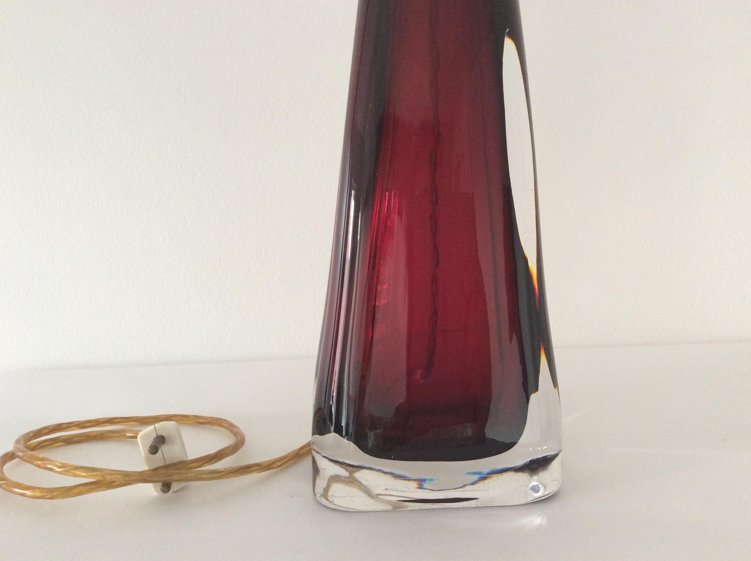Table lamp, ruby-red with clear glass, designed by Carl Fagerlund.
Produced by Orrefors in Sweden. Signed at the top and bottom. The lamp is offered without shade.
Measurements: Height with socket, circa 50 cm.

  