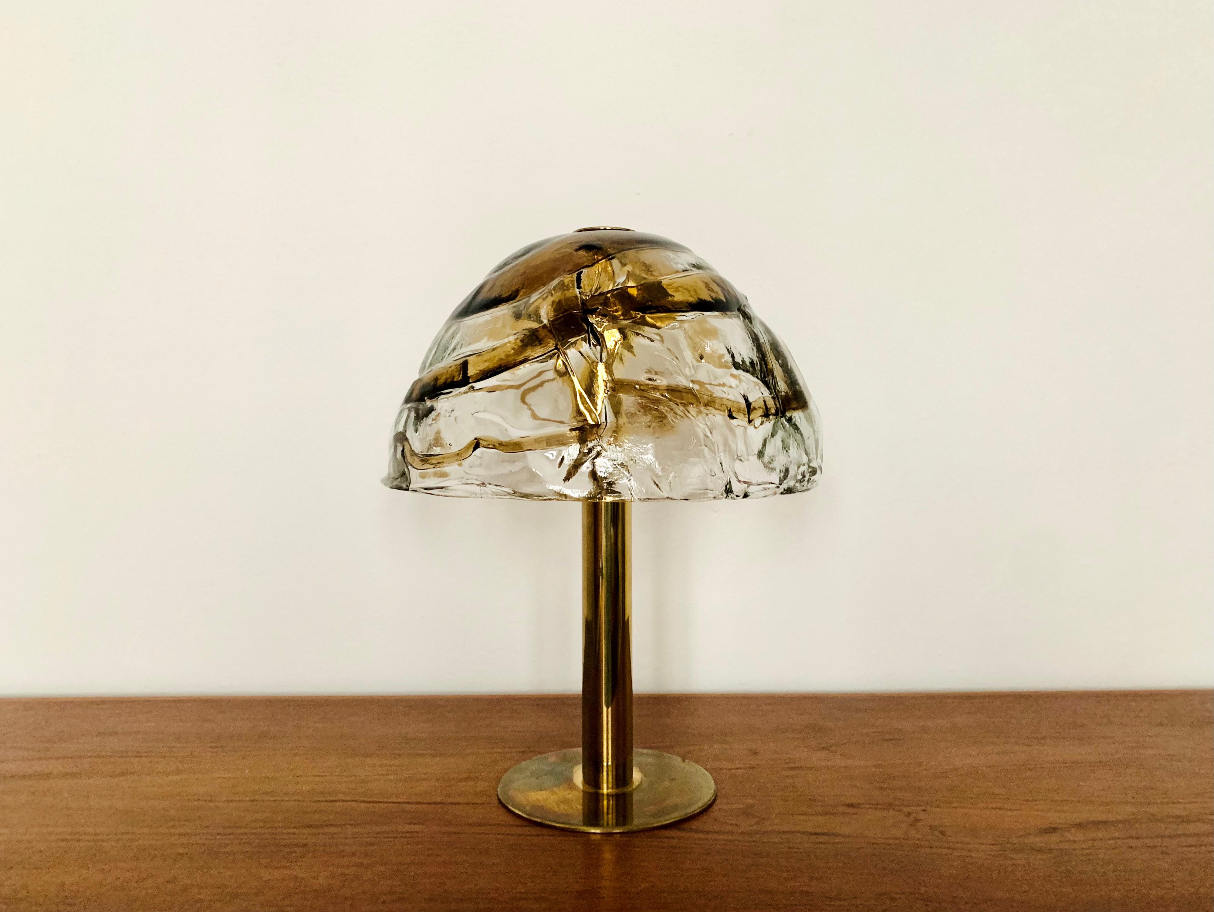 Stunning Murano glass table lamp from the 1960s.
The heavy, two-tone structured glass spreads an impressive, sparkling play of light.
Very high quality workmanship and fantastic design.

Design: J.T. Squid
Manufacturer: Franken KG

Condition:

Very