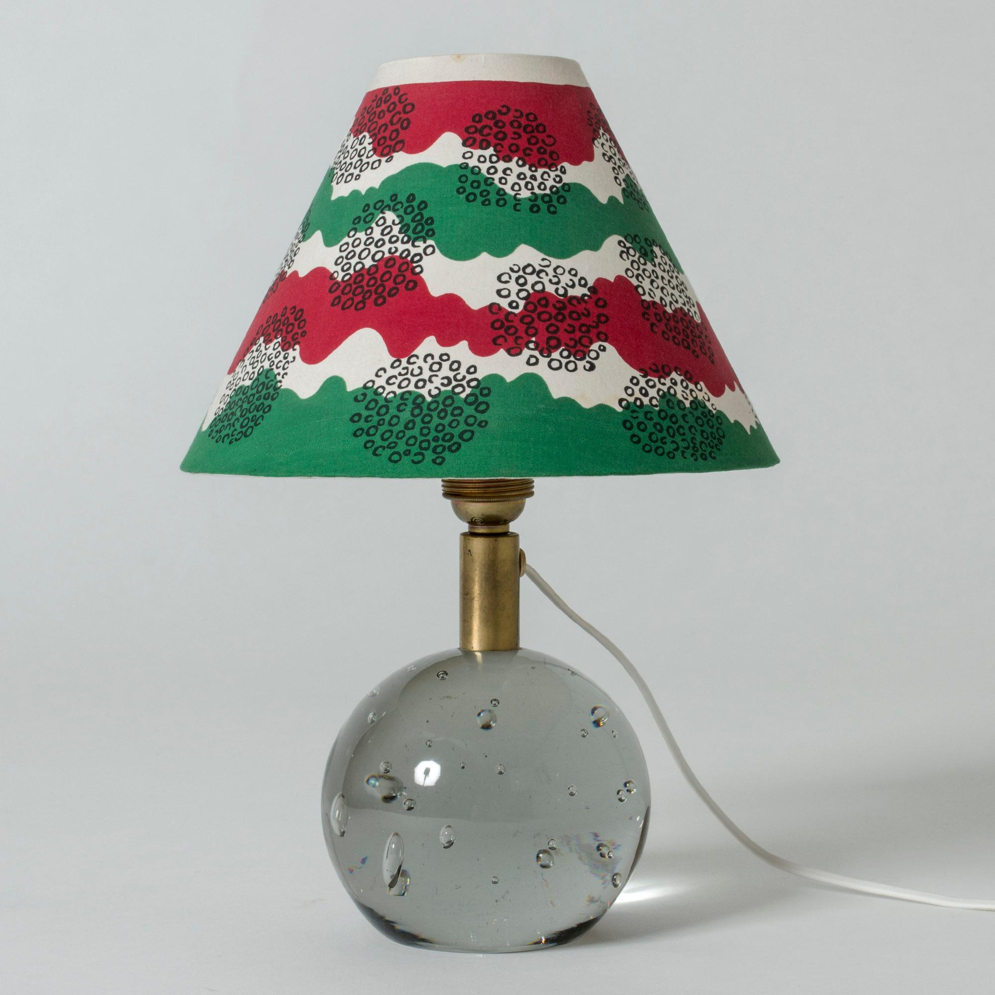 Rare, early table lamp modell 1819 by Josef Frank, made from glass and brass. Weighty round glass base with bubbles caught inside. Colorful shade in green, red and white.