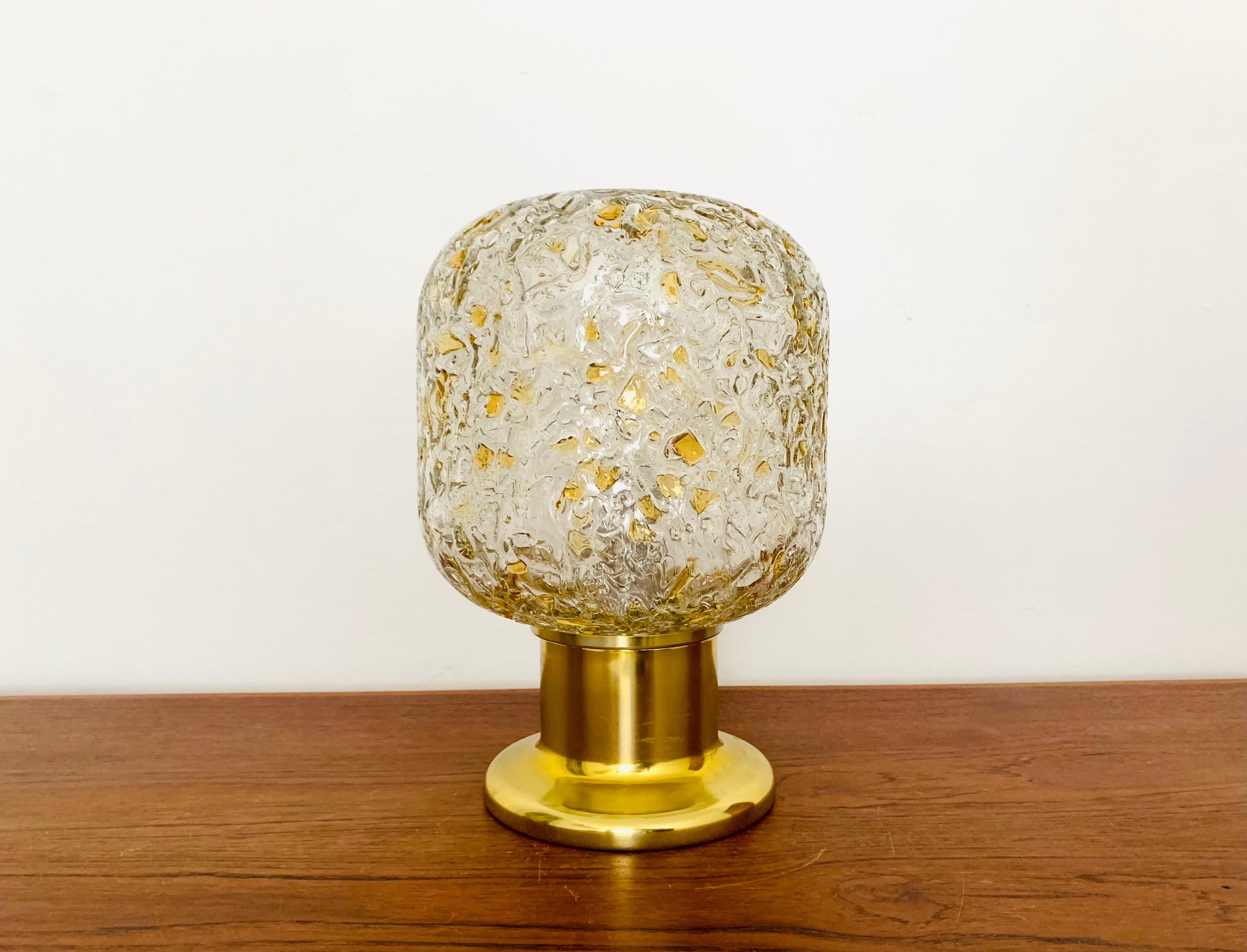 Very nice gold table lamp by Doria from the 1960s.
Very elegant Hollywood Regency design with a fantastically glamorous look.
The structure in the glass creates a spectacularly sparkling light.

Condition:

Very good vintage condition with