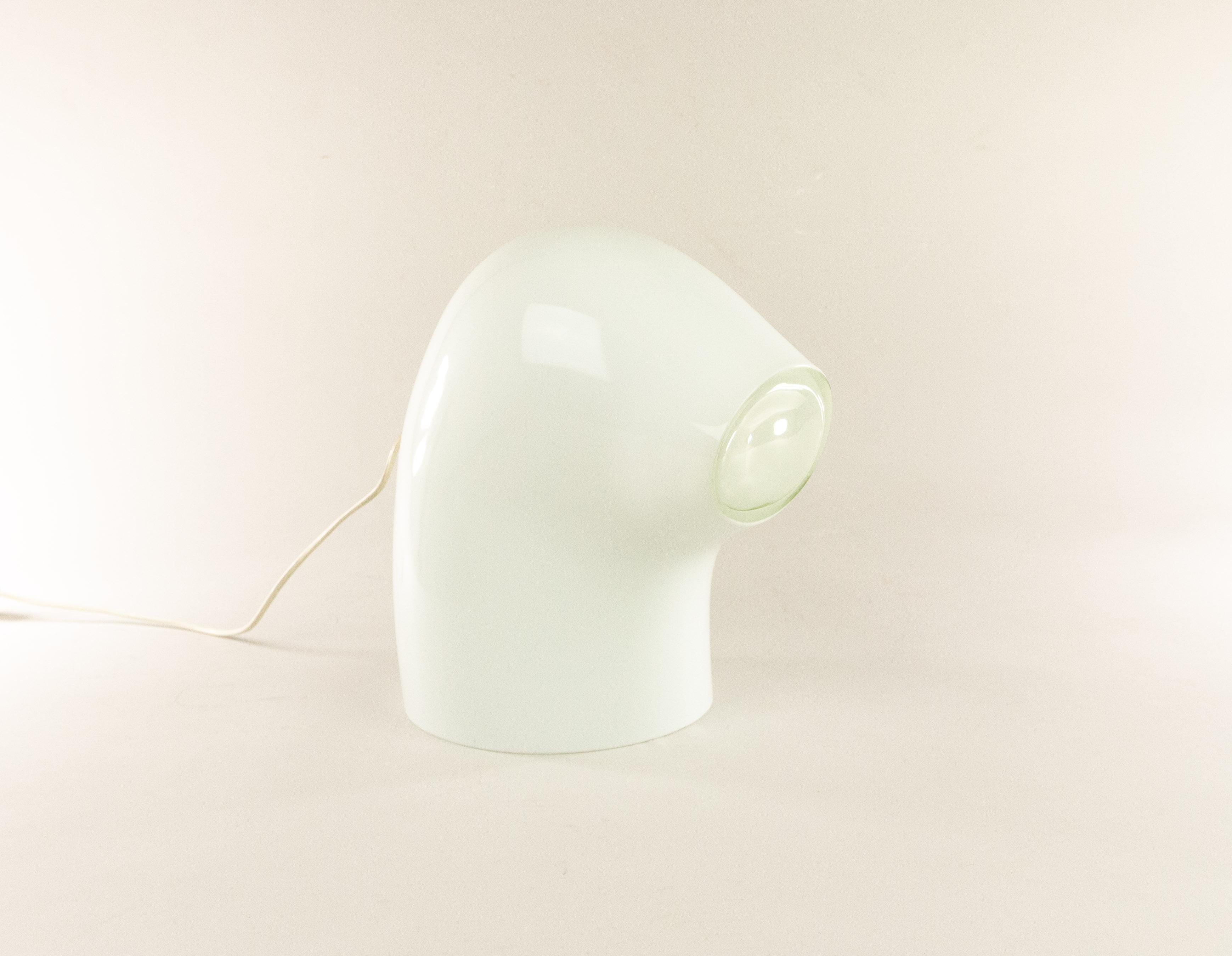 Rare and decorative table lamp L 290 designed by Gino Vistosi for Vetreria Vistosi in the 1970s. It is executed in opaline white Murano glass.

The lamp is an object in itself, and also provides concentrated light through the built-in lens. The