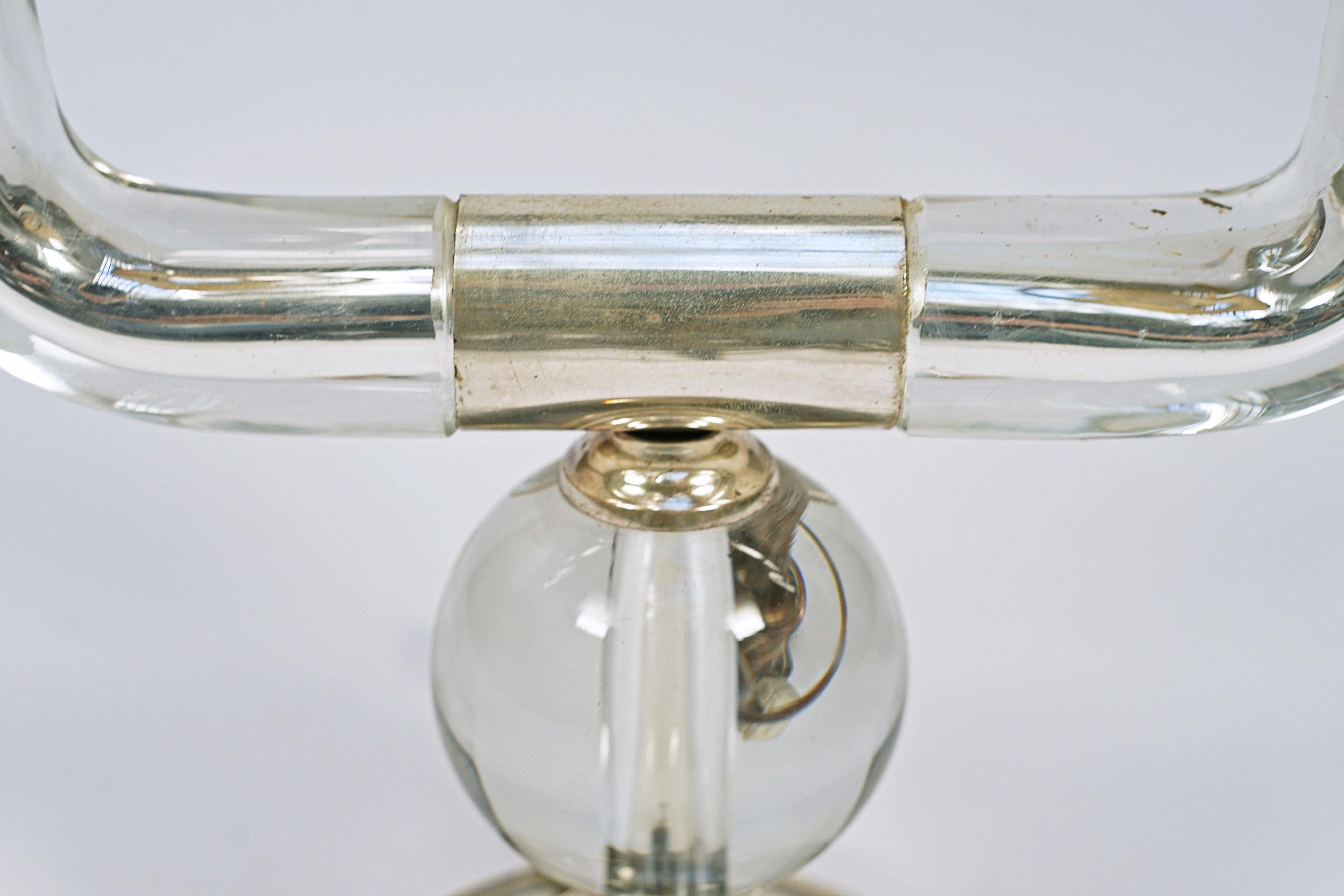 Zweiflammige Tischleuchte, entworfen von Jacques Adnet (1901-1984). Kristall und versilberte Bronze.

Frankreich, CIRCA 1940.