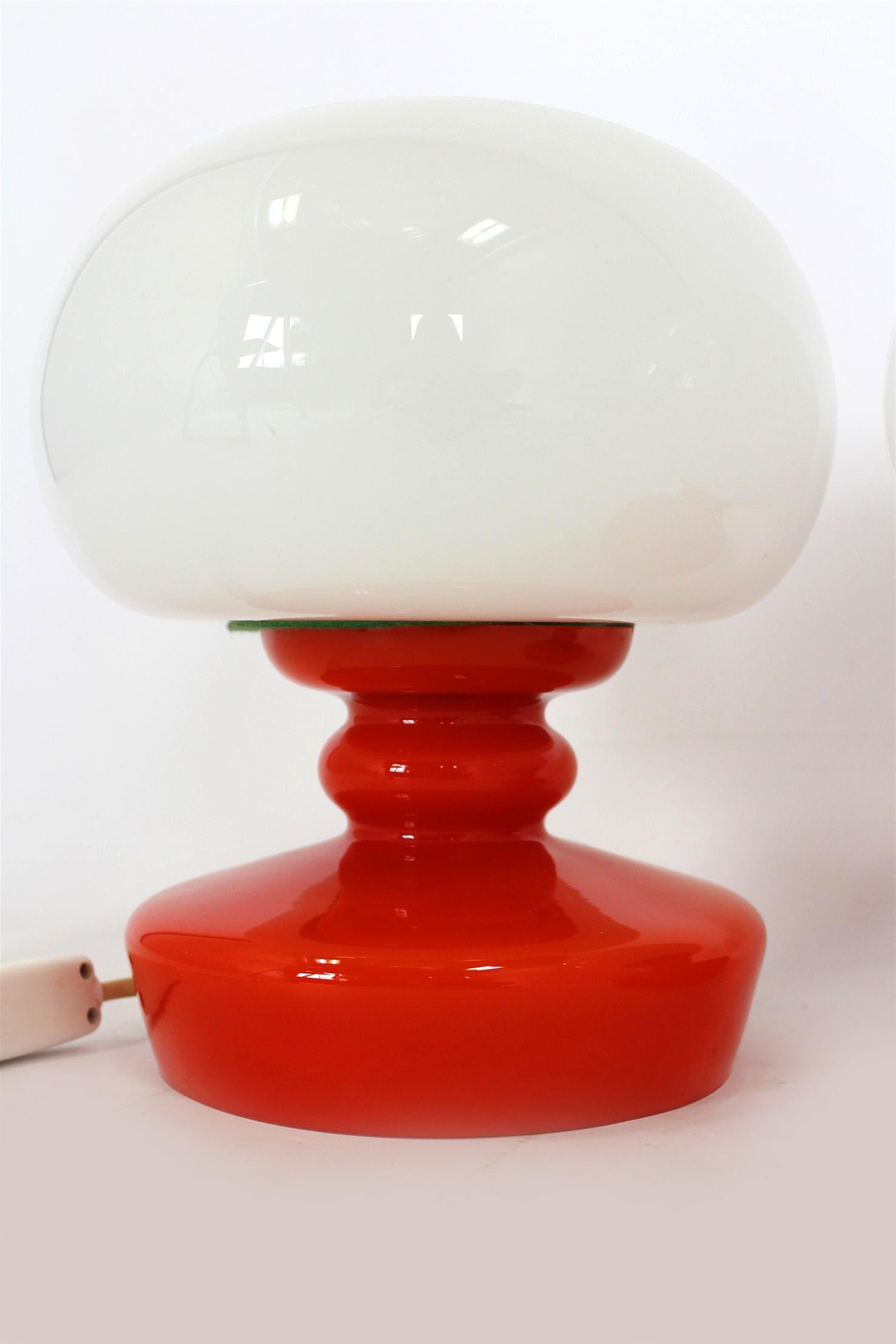 
Pair of vintage table lamps made of opaline glass and red lacquered glass bases, produced by Osvetlovaci Sklo in former Czechoslovakia in the 1970s. Design attributed to Štěpán Tabery.
Each lamp features a mushroom-shaped white glass shade and a