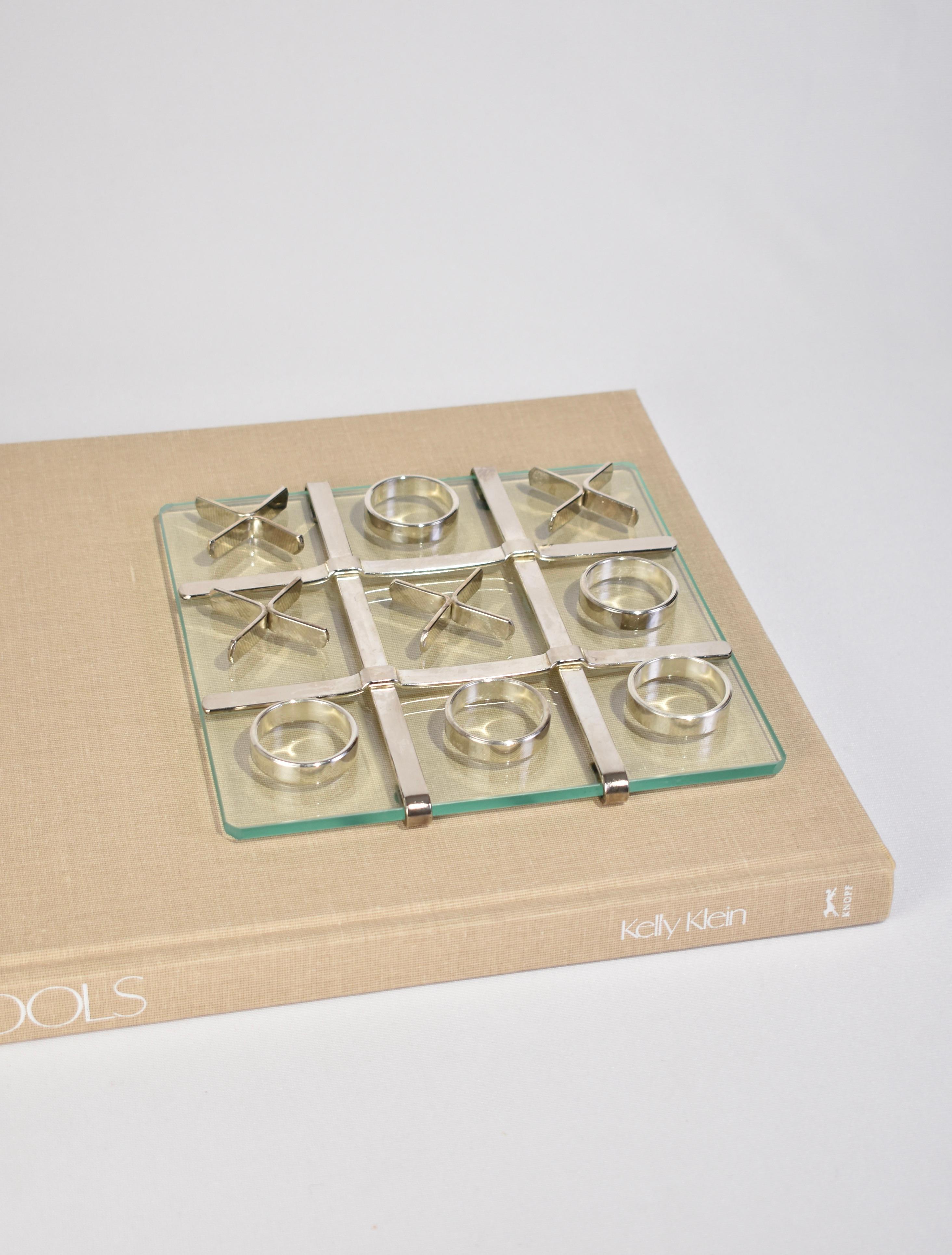 Stunning vintage tic-tac-toe set with a glass base, silver detail and ten silver pieces.

Dimensions:
Board measures 8