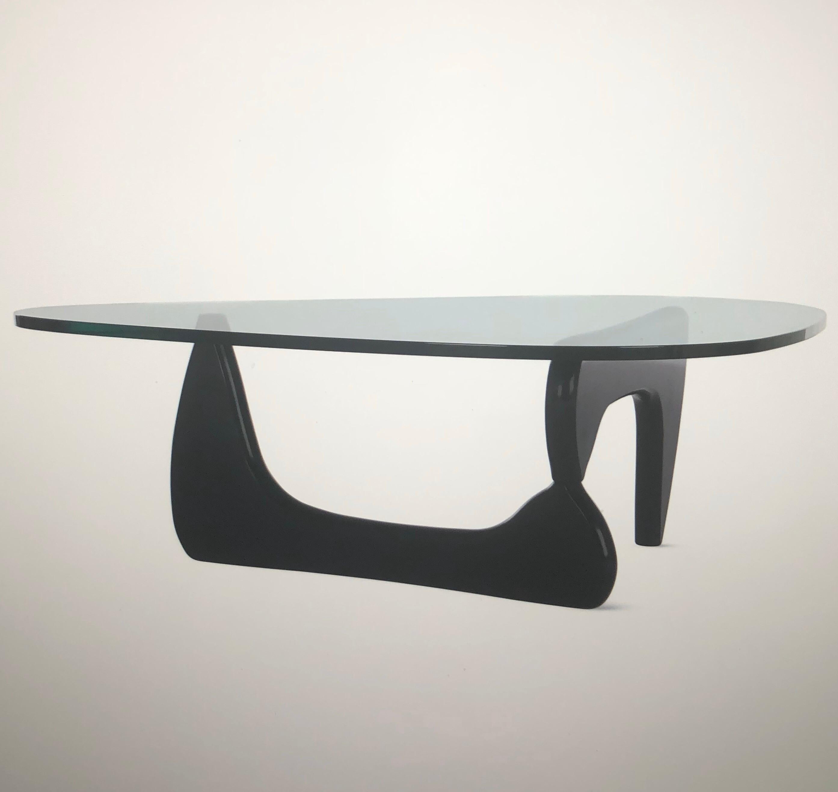 Glass top coffee table by Isamu Noguchi for Herman Miller, circa 2000s. 

This authentic table has Noguchi’s signature etched into the side of the glass with the manufacturer’s medallion present on the underside of the base. The table is made of a