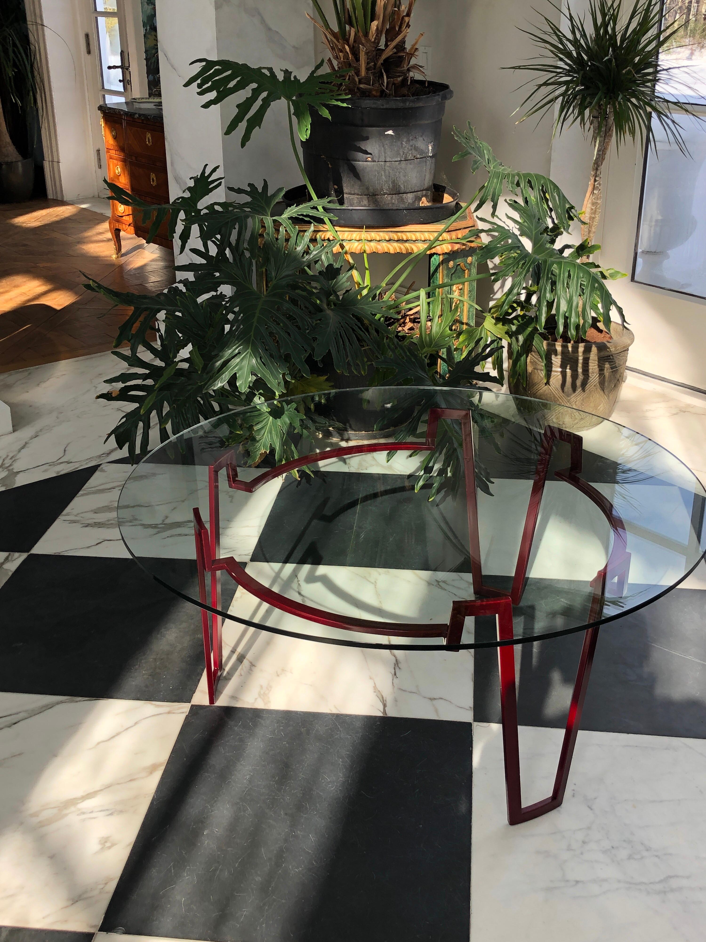 This elegant Modern coffee table is powder coated in a deep red. Unlike spray paint this process of baking on the finish at 400 degrees makes the coloring more resilient to chipping and prevents it from rusting, so it can be used indoors or outdoors.