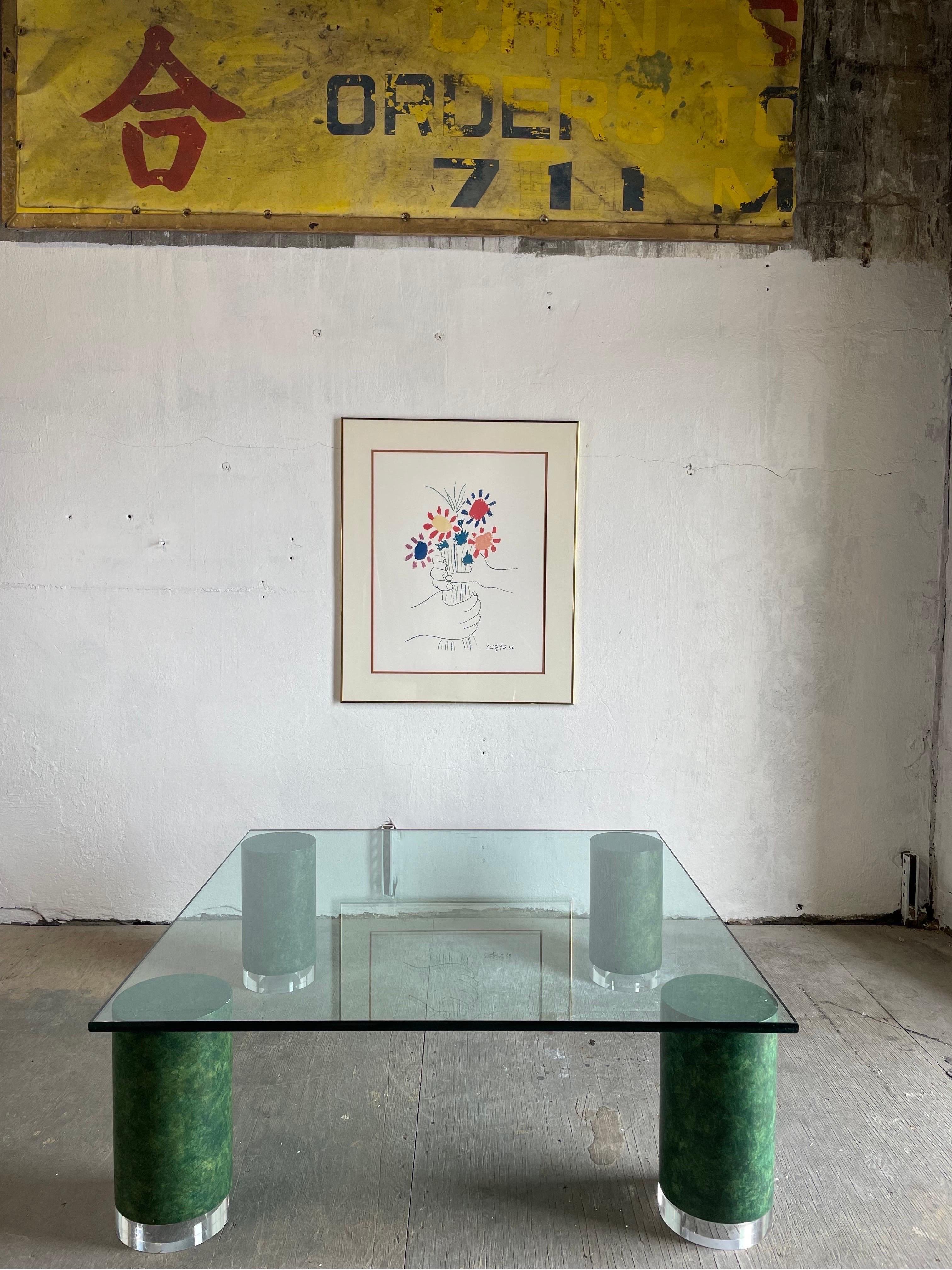 Striking Mid-Century Modern thick glass-top coffee table resting on faux marble/Malachite and lucite legs.

Curbside delivery available $300.