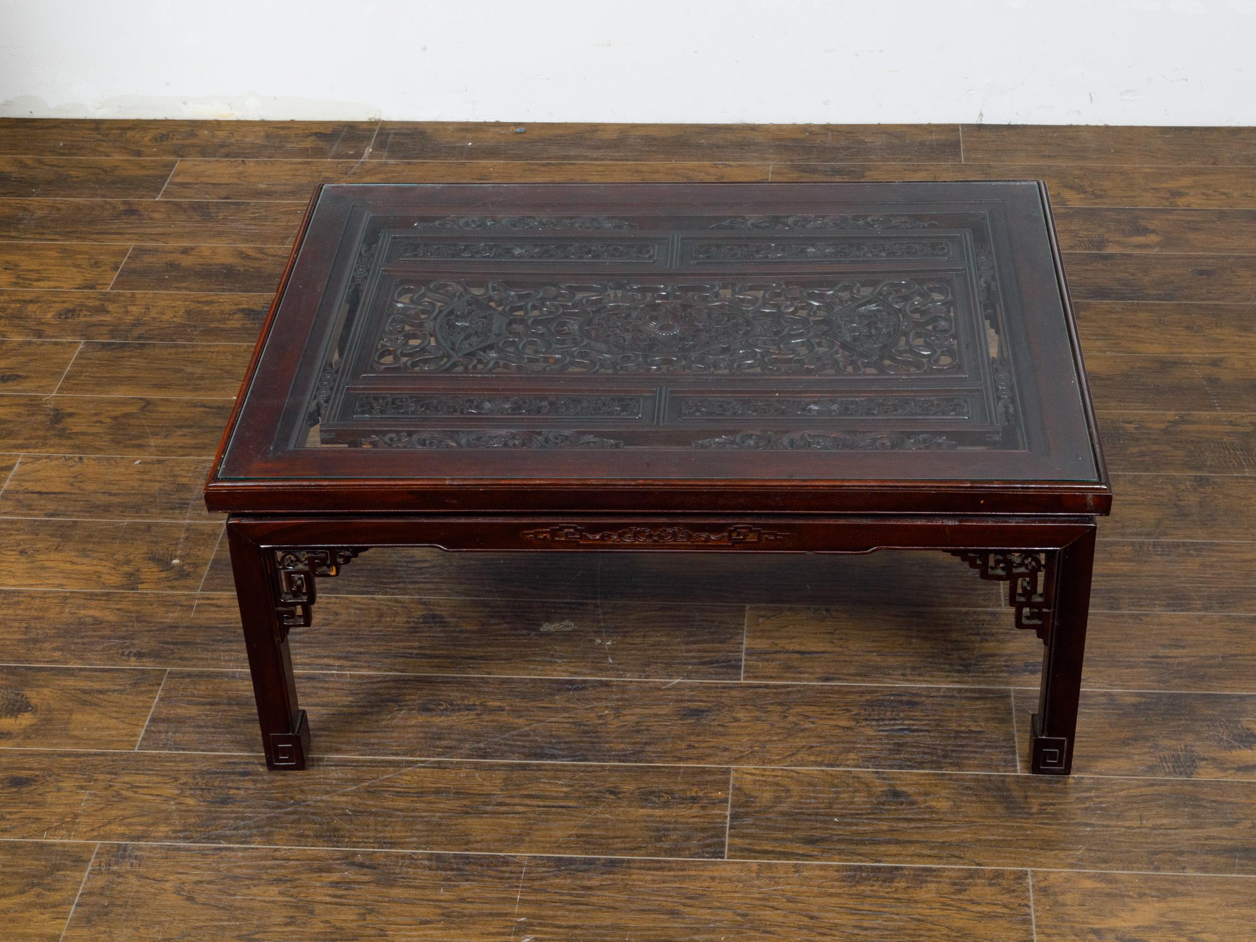 Asian Glass Top Coffee Table with Fretwork Motifs and Scrolling Feet, circa 1950 For Sale