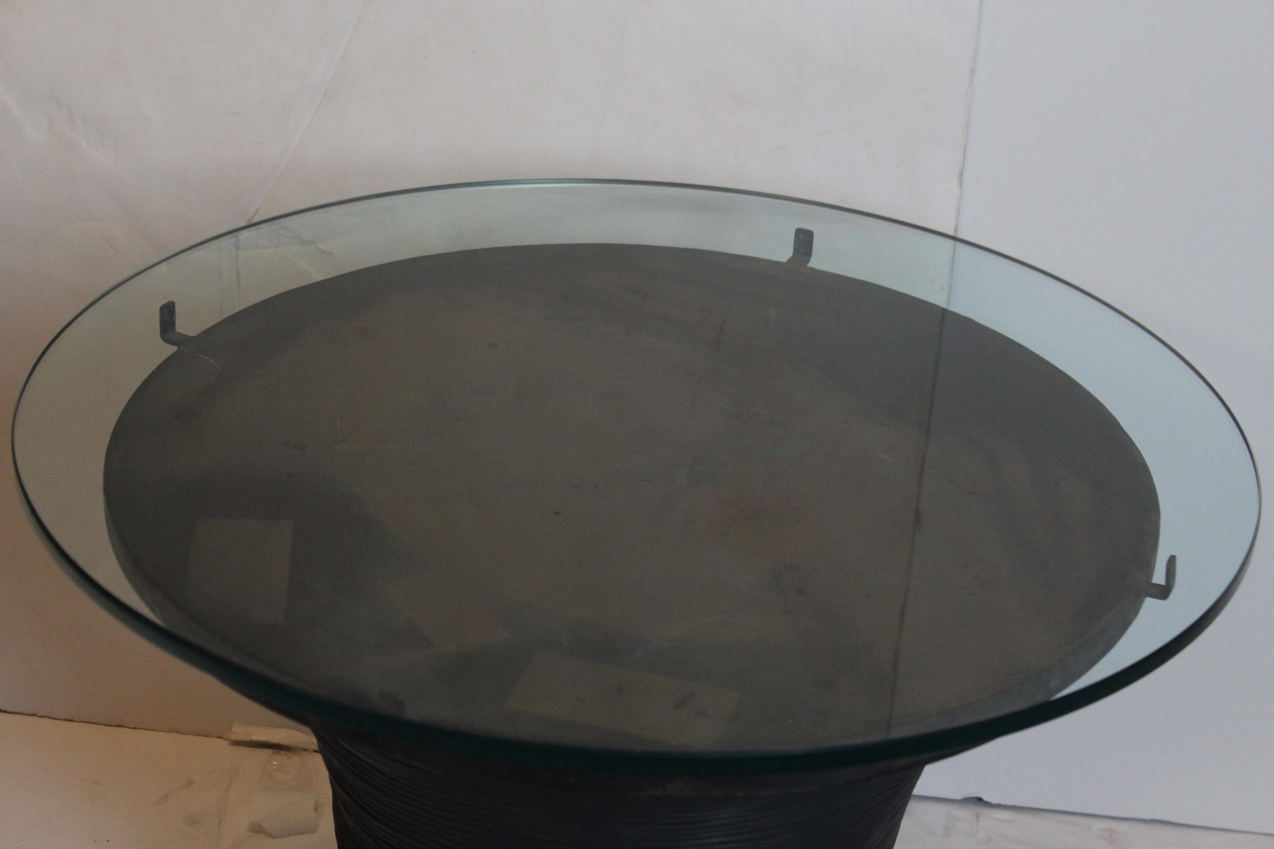 Round shape glass top drum accent table. The base is solid metal wrapped in tin metal. Beautiful piece of furniture.