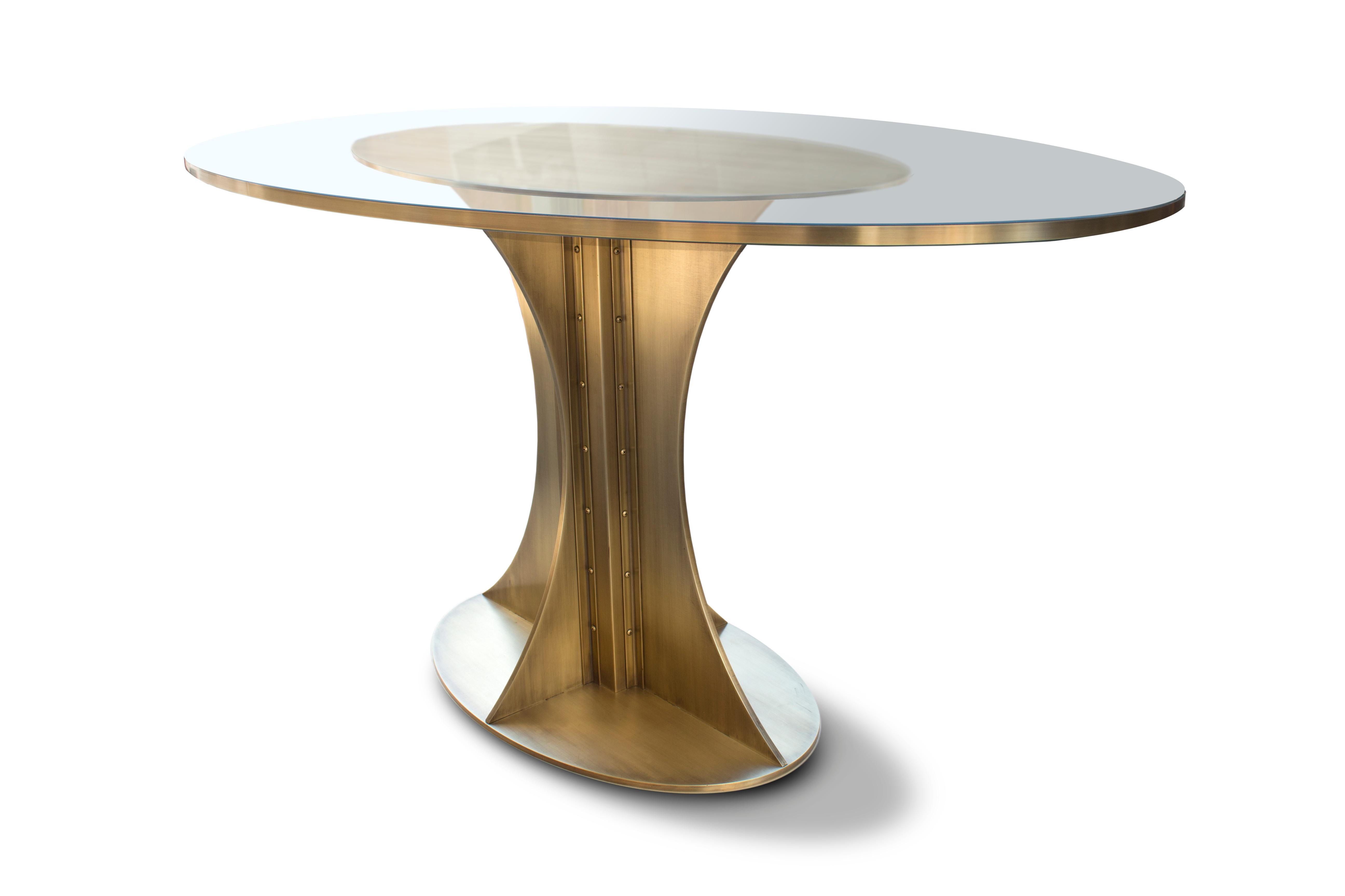The Empire pedestal table is a powerful addition to the Mark Jupiter Elegant Industrial Collection. The massive solid brass center pedestal is inspired by the Spire Cap of the Empire State Building; this exquisite brass banded table will not only be