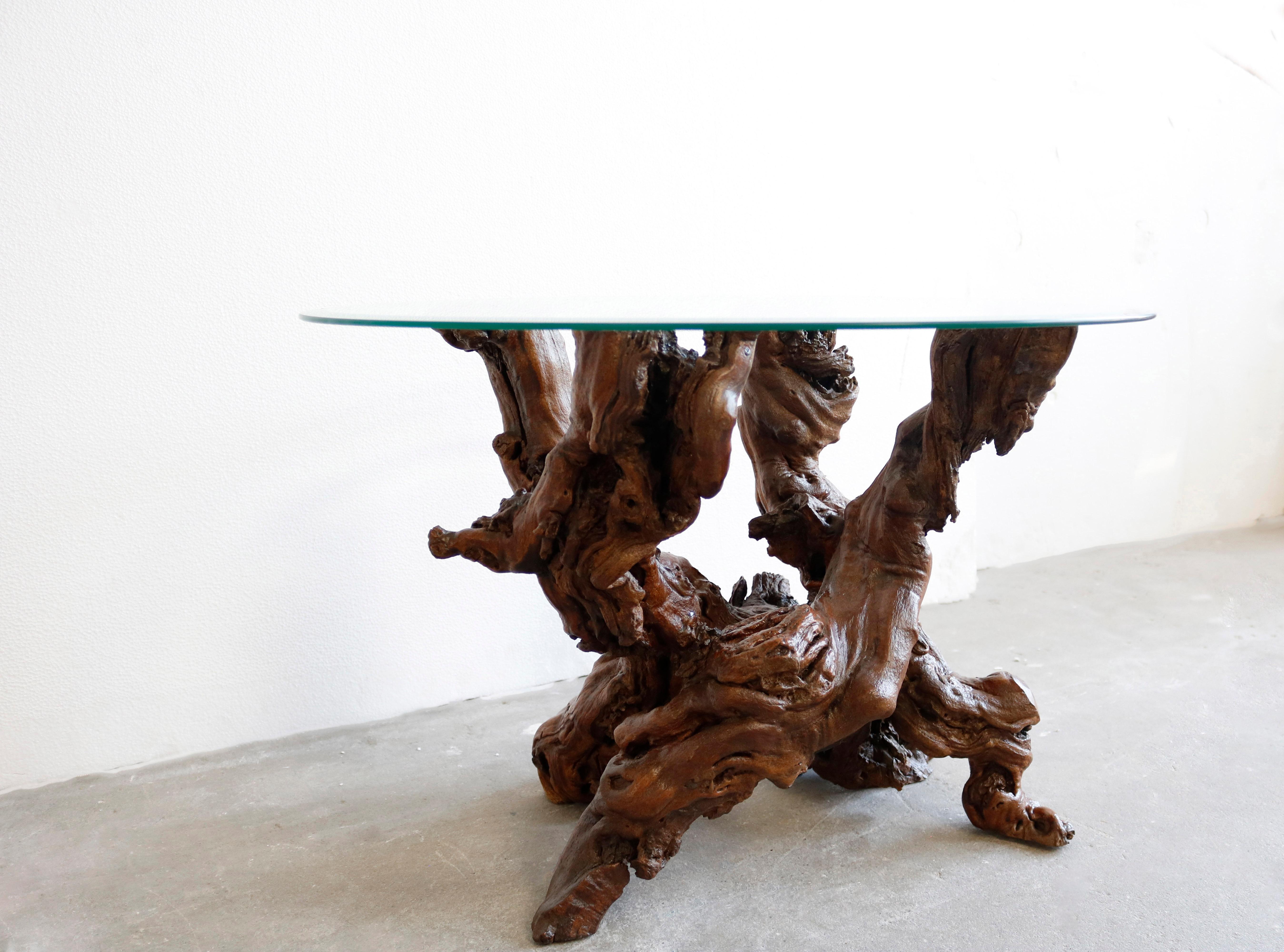 This gueridon has a circular tempered glass top paired with a dense, single form sculptural base made of redwood.
