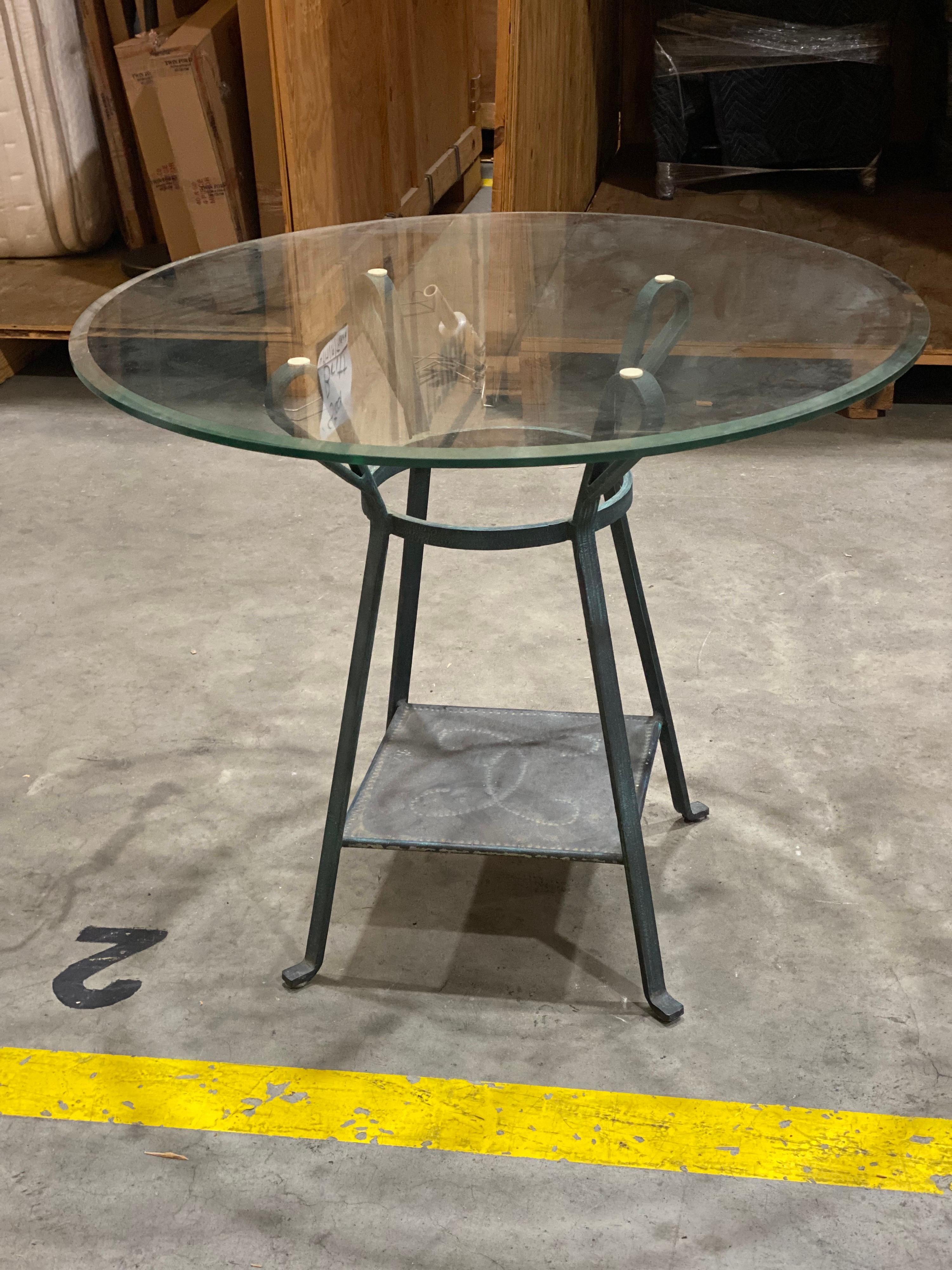 Glass top metal table
Sweet metal base with pressed dot motif on shelf. Looped metal holding a beveled glass top. The finish looks like a worn verdigris finish. 

Measures: 36