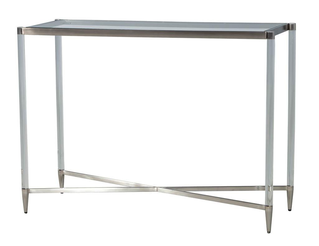 Modern X base combined with glass, brushed metal and acrylic. This designer console has all the elements to create a modern luxurious understated setting.