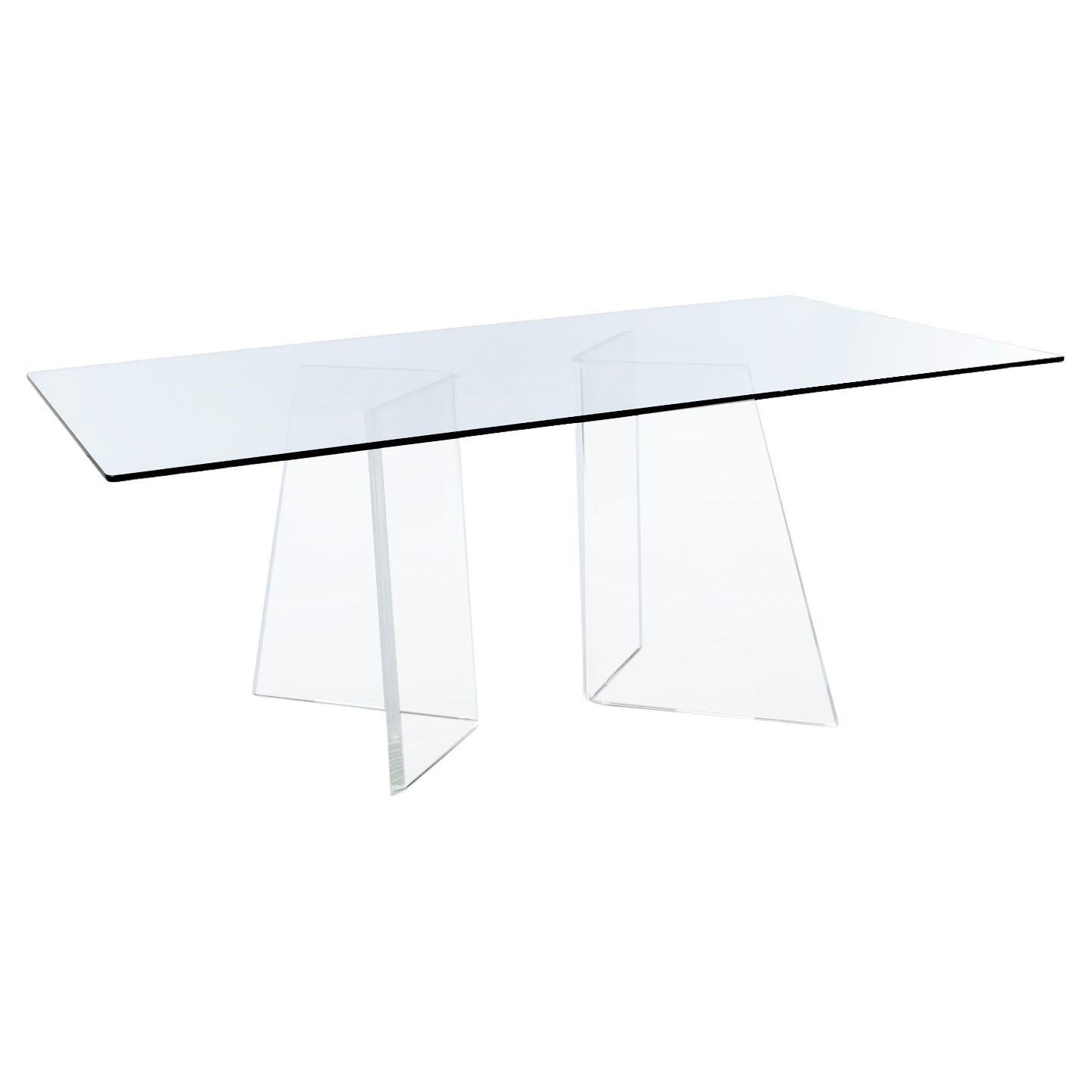 This gorgeous Nineteen-Laties Lucite table is almost ghostly as it the clear glass top and acrylic pedestals seem to vanish in the sight line. The two thick Lucite pedestals are asymmetric wedges resembling a three dimensional scalene triangle. The