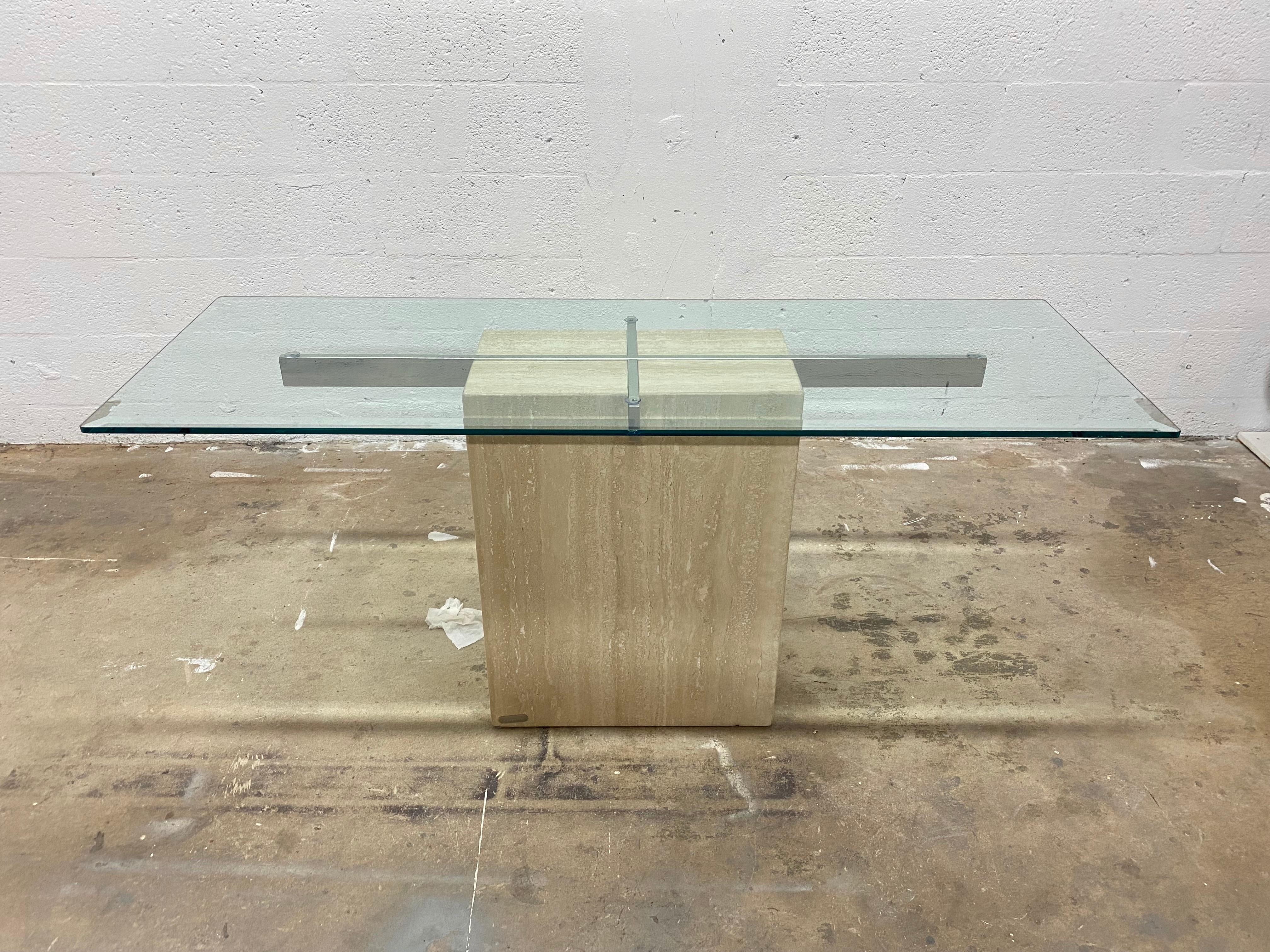 Rectangular travertine console table base with beveled glass top supported by chrome bars manufactured by Artedi, 1980s.