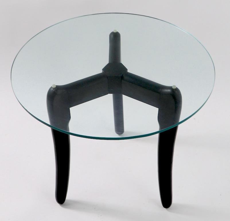 Round plate glass top table with sculptural wood base in black paint finish. Form attributed to Adrian Pearsall but undocumented. Top glass 3/8 inch thick.