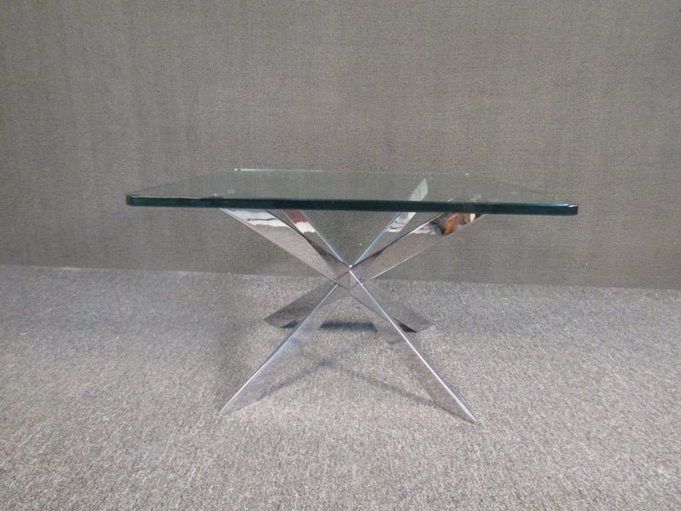 Vintage modern side table with an interesting geometric chrome base and thick glass top. This table is eye-catching yet easy to pair with more colorful surroundings. Please confirm item location with seller (NY/NJ).