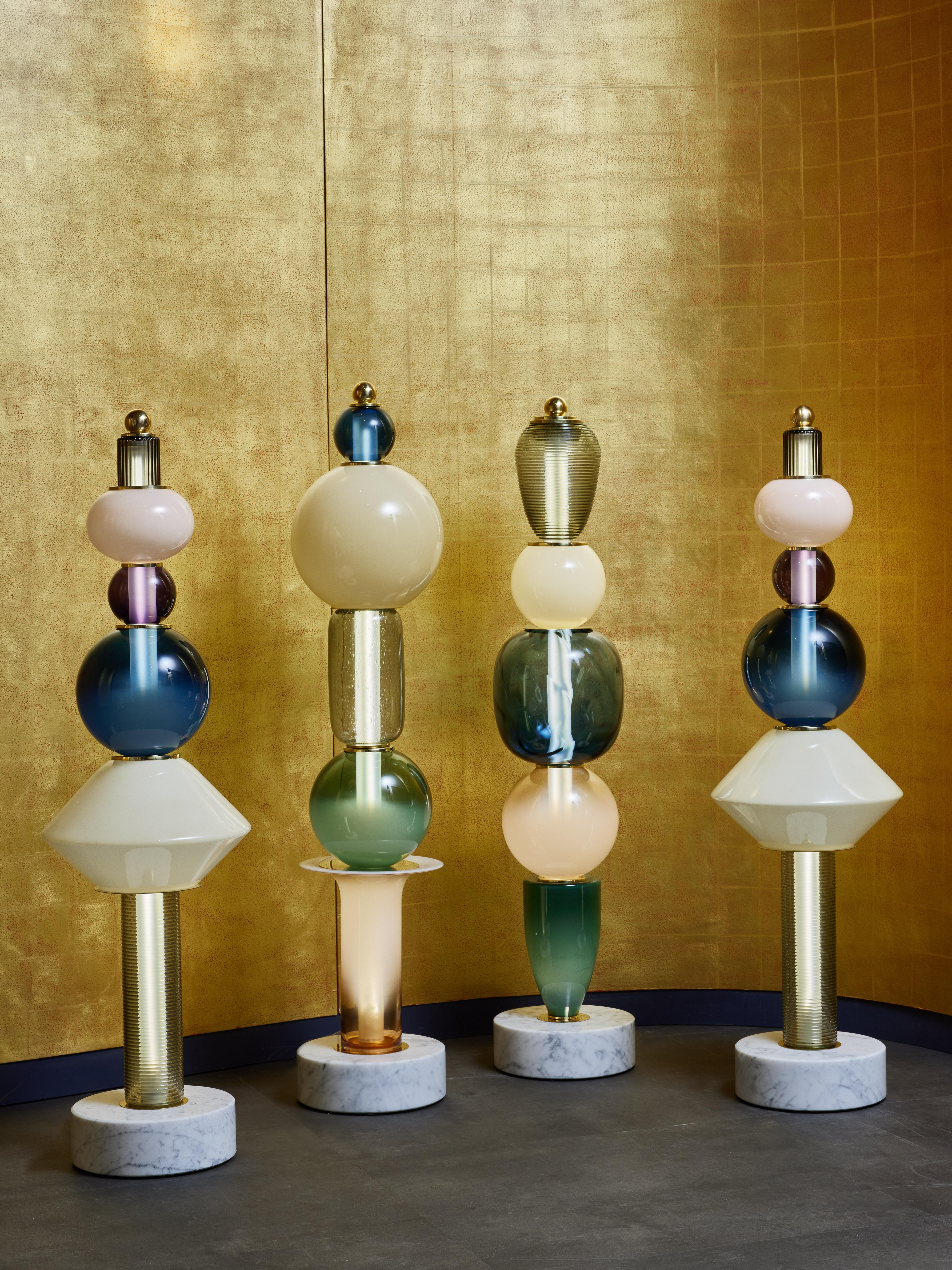 Built like totems, we used a Carrara marble base then stacked different Murano glass parts in various colours and shapes, alternating with some brass discreet elements.

Sold separately, price displayed for one floor lamp