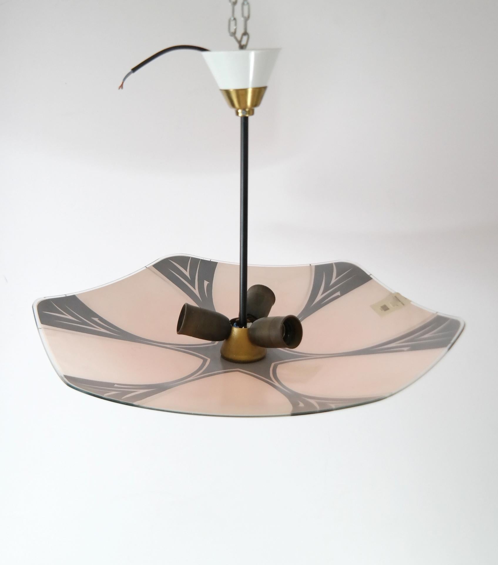 This simplistically beautiful Mid-Century light piece resembles a glass umbrella hanging from the ceiling. While technically a chandelier, because it has three light sources, this vintage piece from the 1960s can be mistaken for a pendant light as