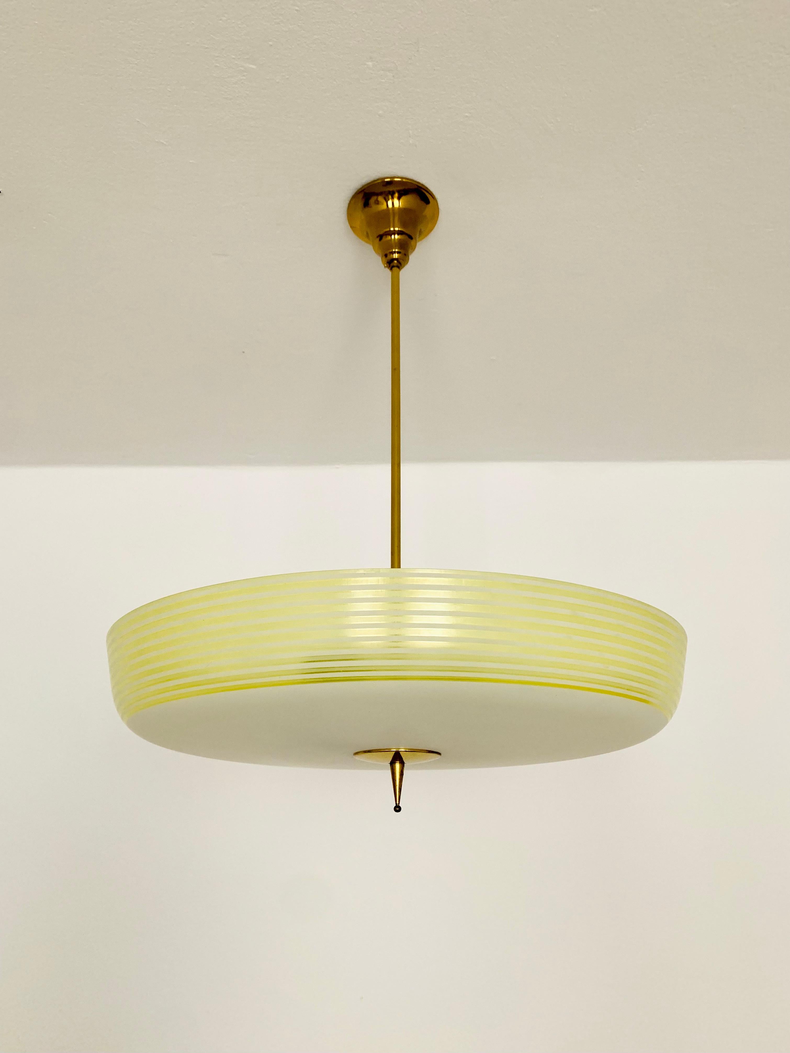 Wonderful ceiling lamp from the 1950s.
The glass has a special shape and is designed in multiple colors.
The design and the materials used create a comfortable light.
A stunning lamp and a real asset to any home.

Manufacturer: