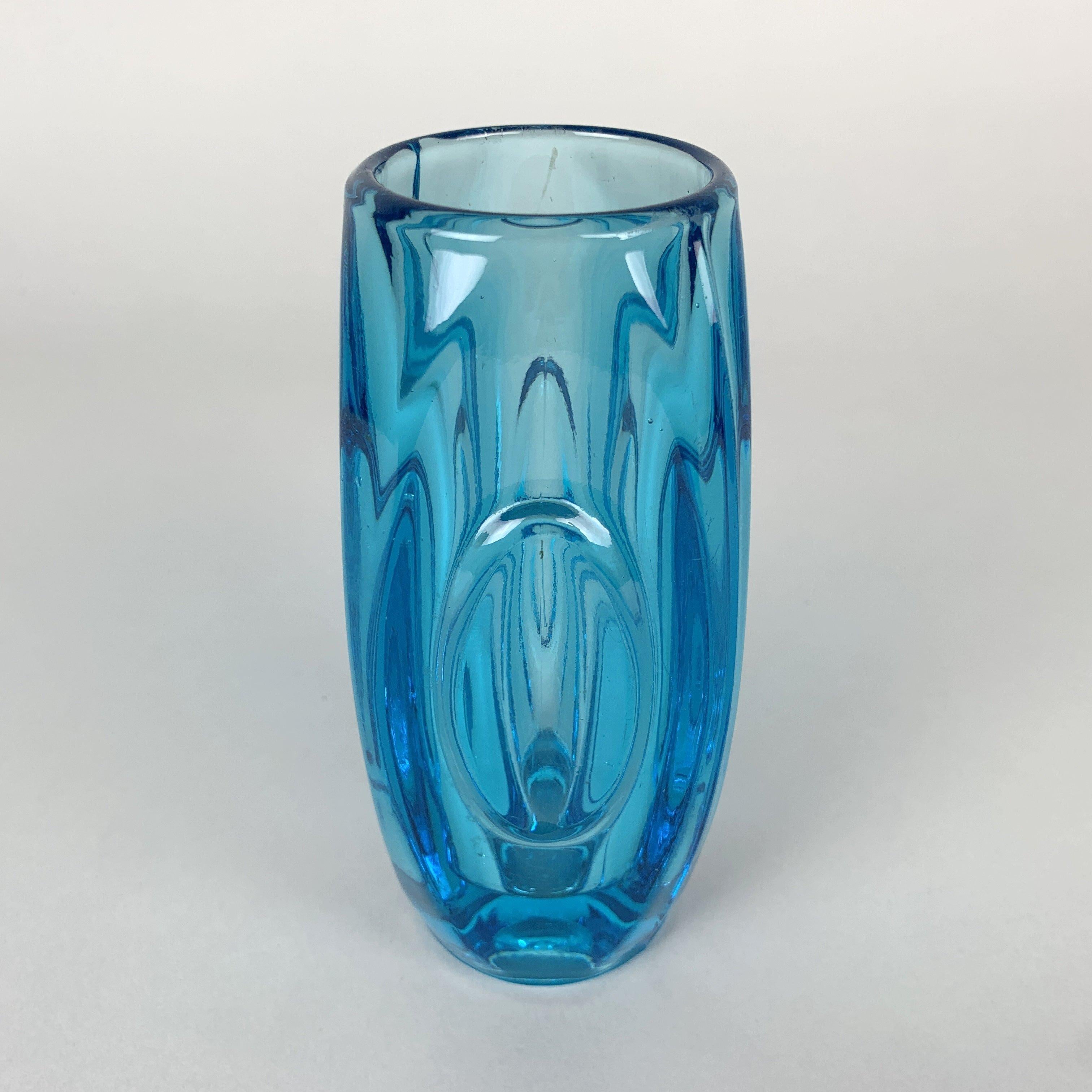 Small blue vase made of pressed glass designed by Rudolf Schrötter in circa 1955 and manufactured by Rosice Glassworks (part of the Sklo Union) in former Czechoslovakia.