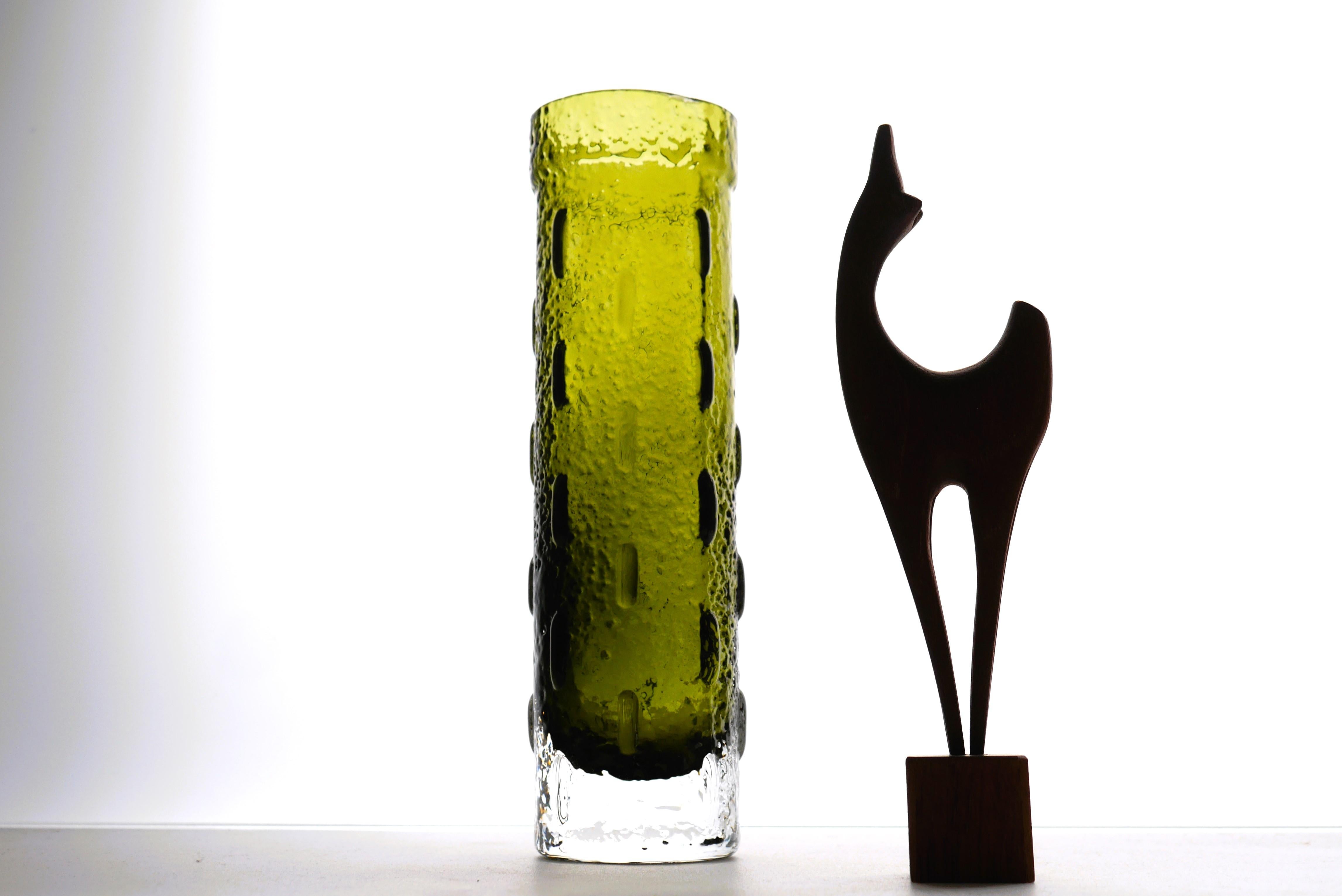 A typically piece of glass art by the talented Tamara Aladin for Riihimäan lasi, Finland. It has a fantastic deep moss green colour and as many of her vases it has a brutalist and modernistic style. This piece has been attributed in several archival