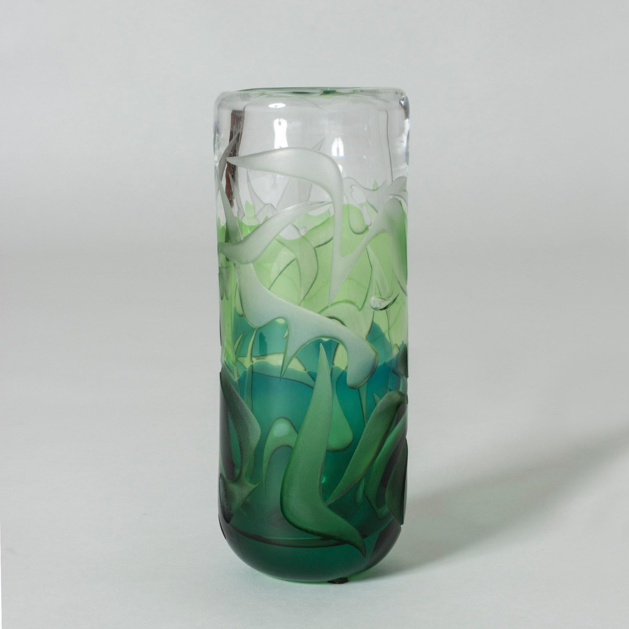 Striking, unique glass vase by Vicke Lindstrand, made with overlay technique. Layers of green and clear glass with an abstract etched pattern that brings an enchanted forest to mind.