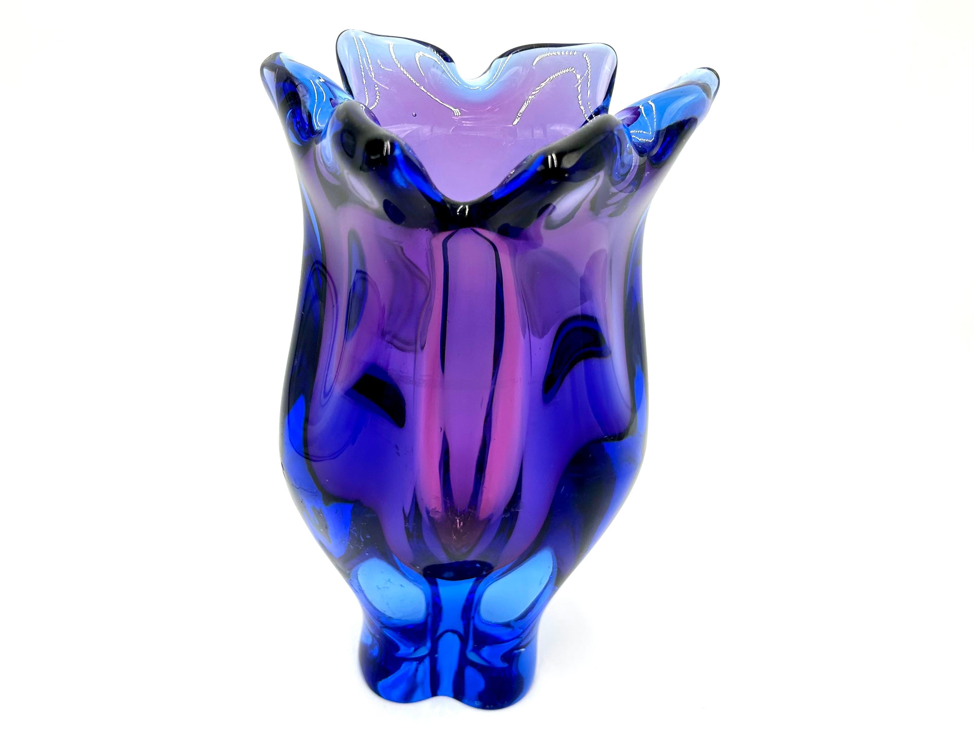 A glass vase with a unique shape in beautiful shades of violet with blue

Produced in the Czech Republic in the 1960s in Huta Chribska.

Very good condition - visible scratches on one side (see photos)

height: 26cm

diameter: 16cm