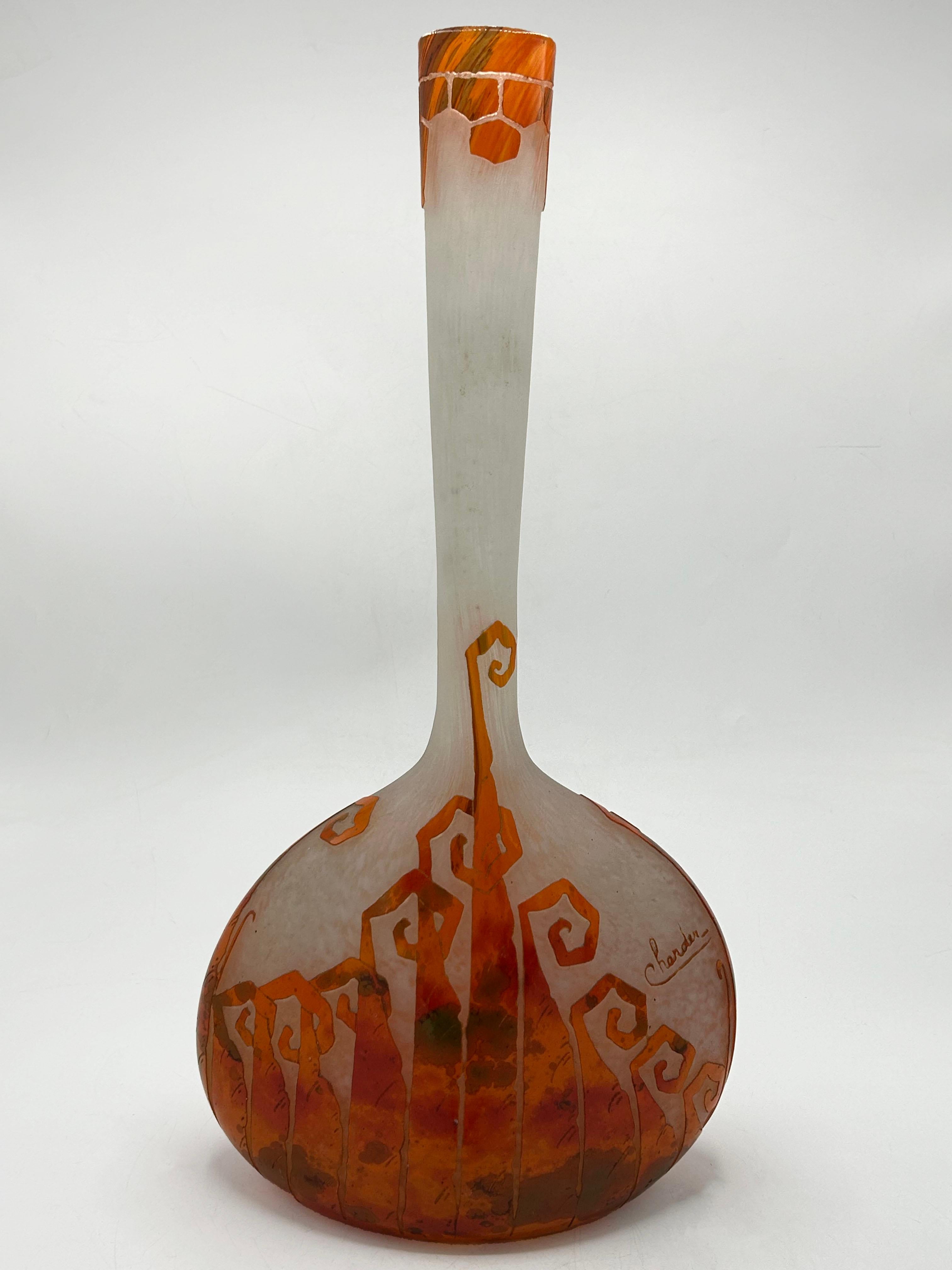 French Charder Le Verre Français Glass Vase
This French glass vase by Charder Le Verre Français features a gourd-like shape with a long, narrow neck that widens at the mouth. Its overall design is asymmetrical, with an irregularly shaped base and an